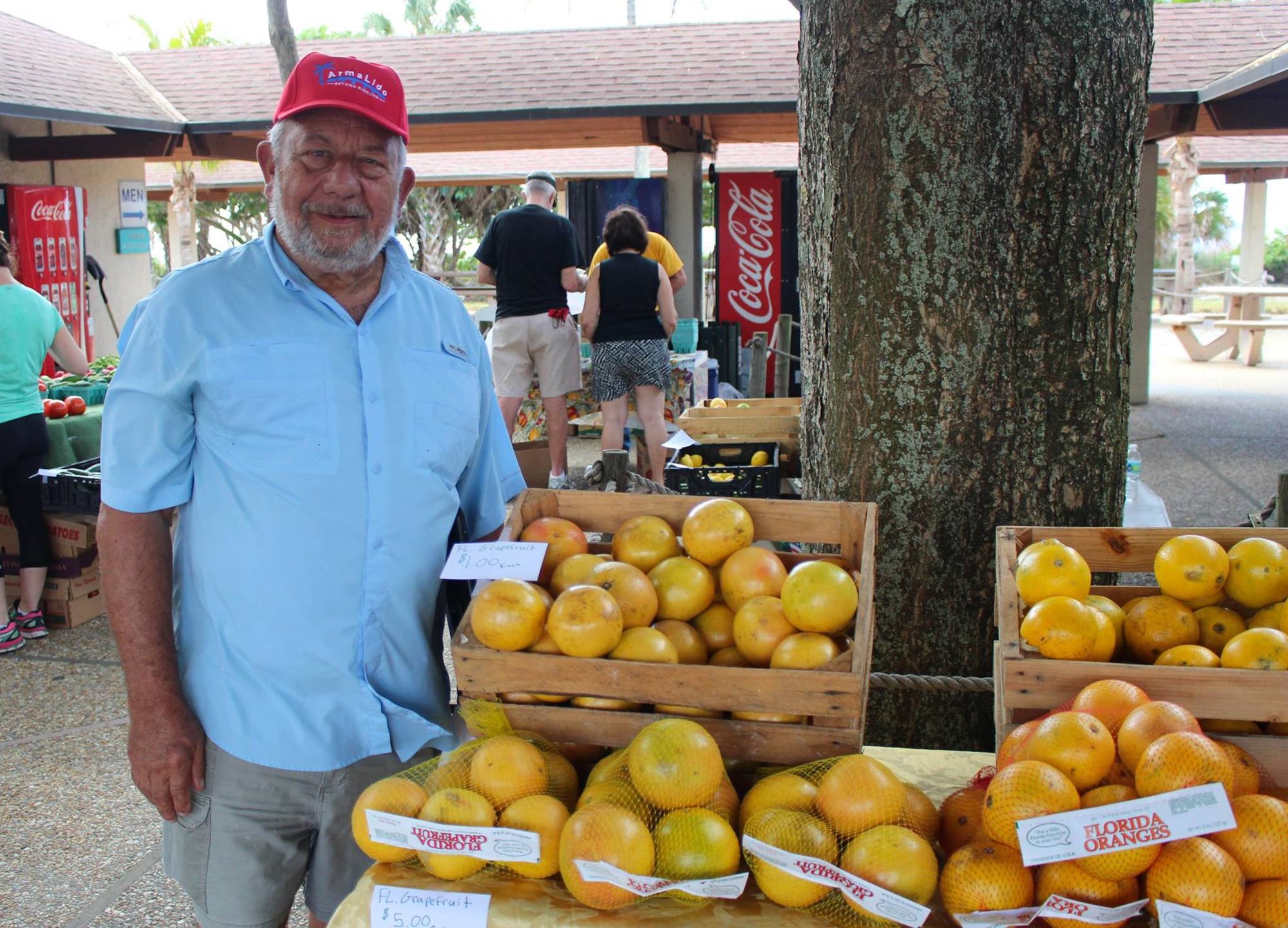 Mike Adkinson poses with fresh fruit at the first Lido Key Veggie Market Nov. 3. Photo courtesy city of Sarasota.