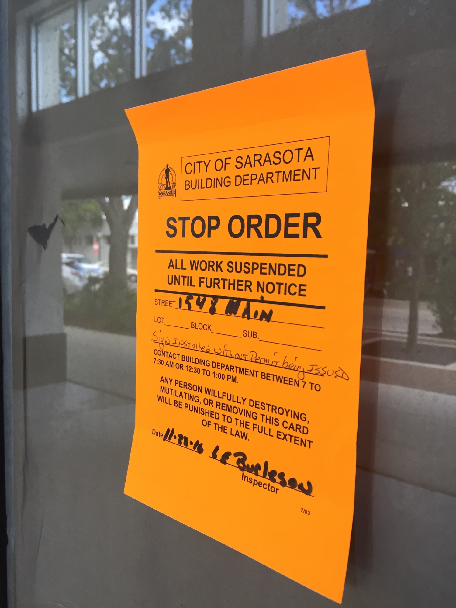 The stop-work order is posted on the door of the property at 1548 Main St.
