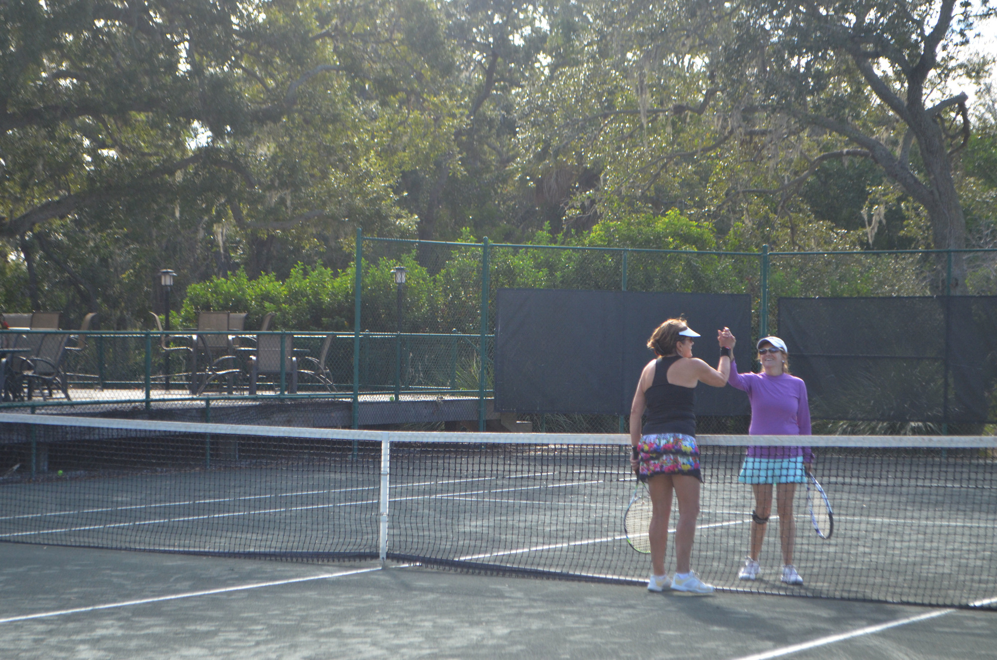 Jayne Meth and Mary Dykun high-five during a Rombo tennis match Nov. 12. 