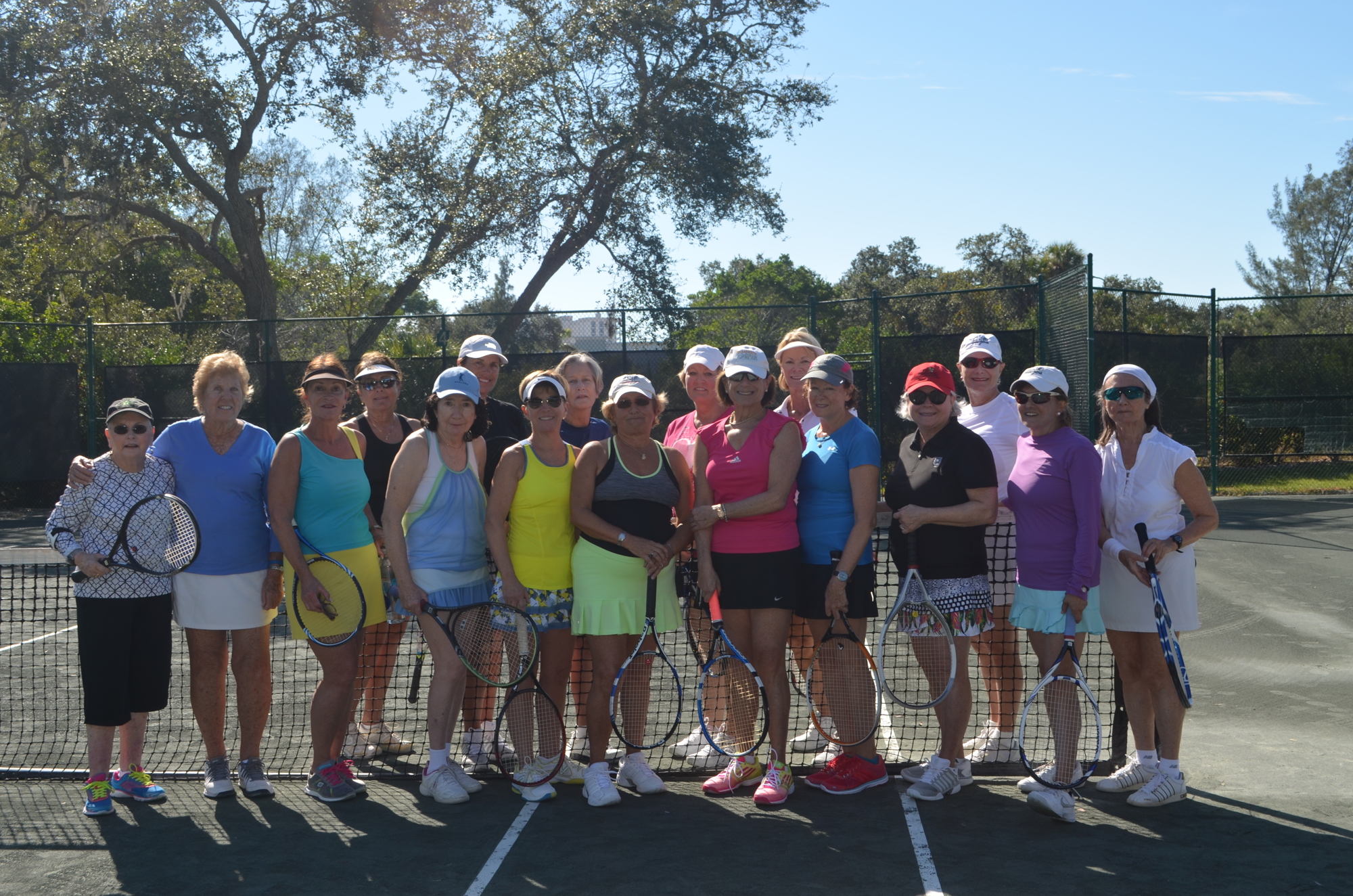 16 members of Rombo smile after a tennis-filled morning on Nov. 12 