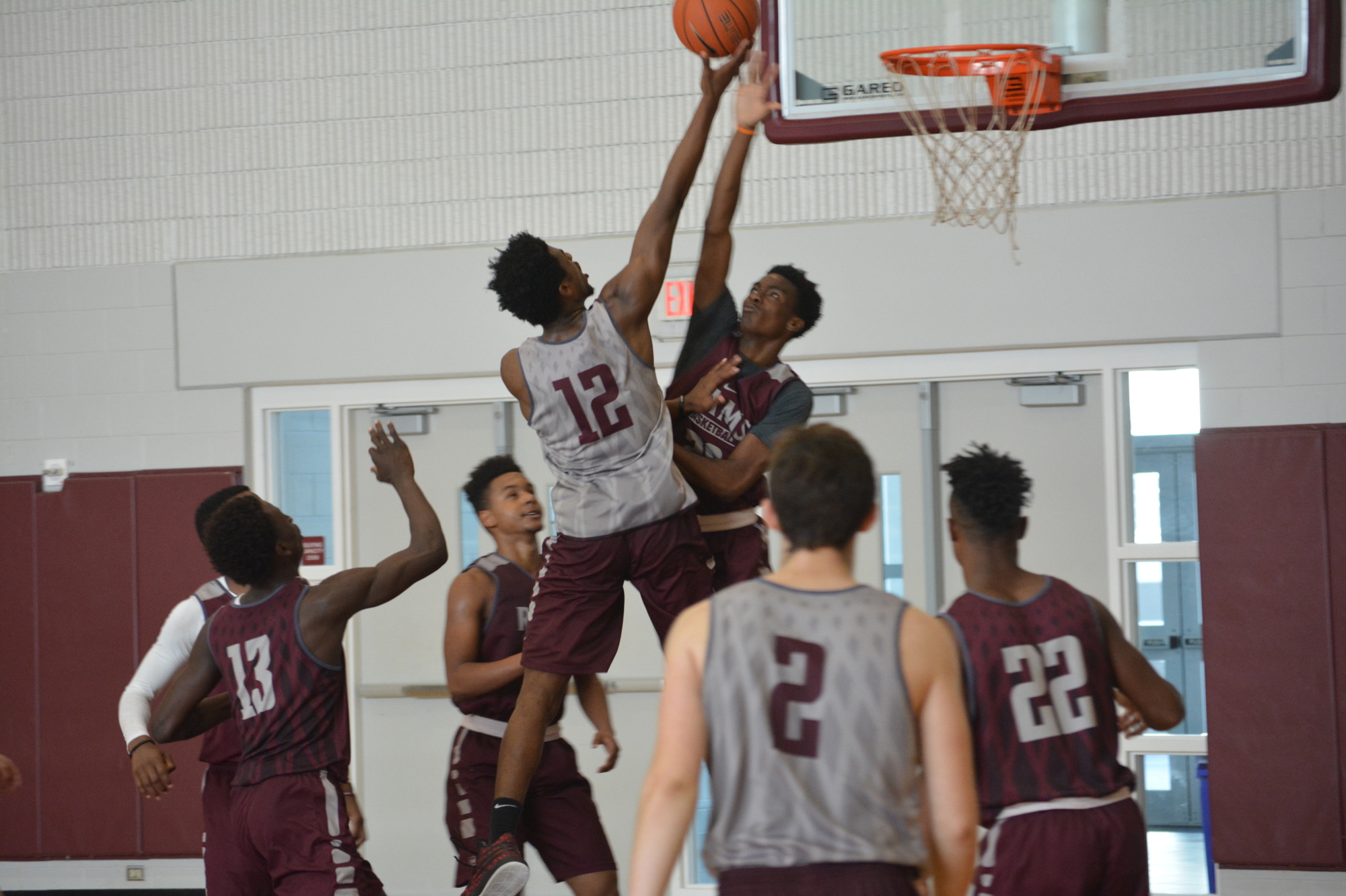 Brion Whitley (#12) puts a layup over a defender during practice.