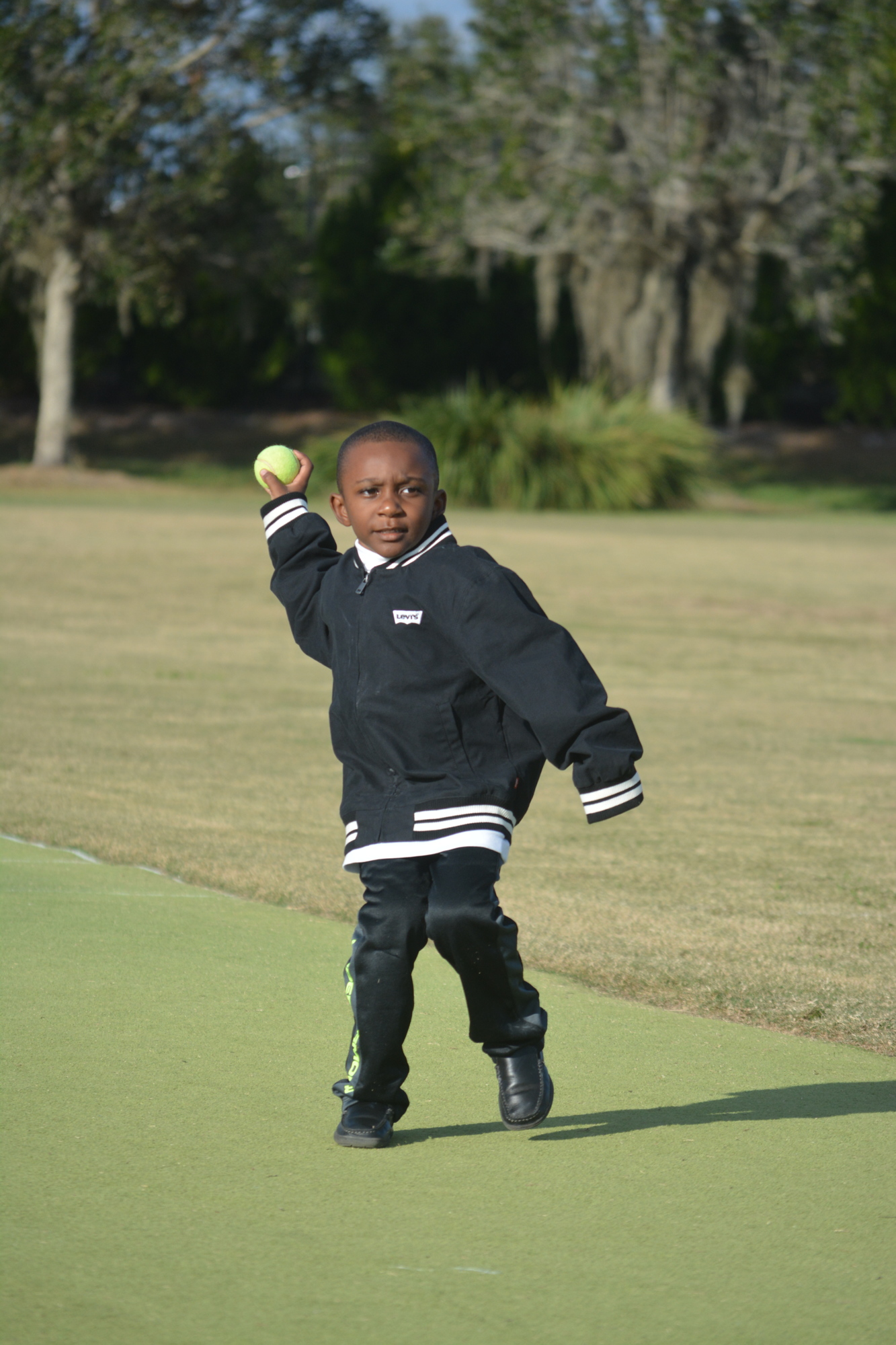 Michael Miles Anderson, 5, bowls a ball.