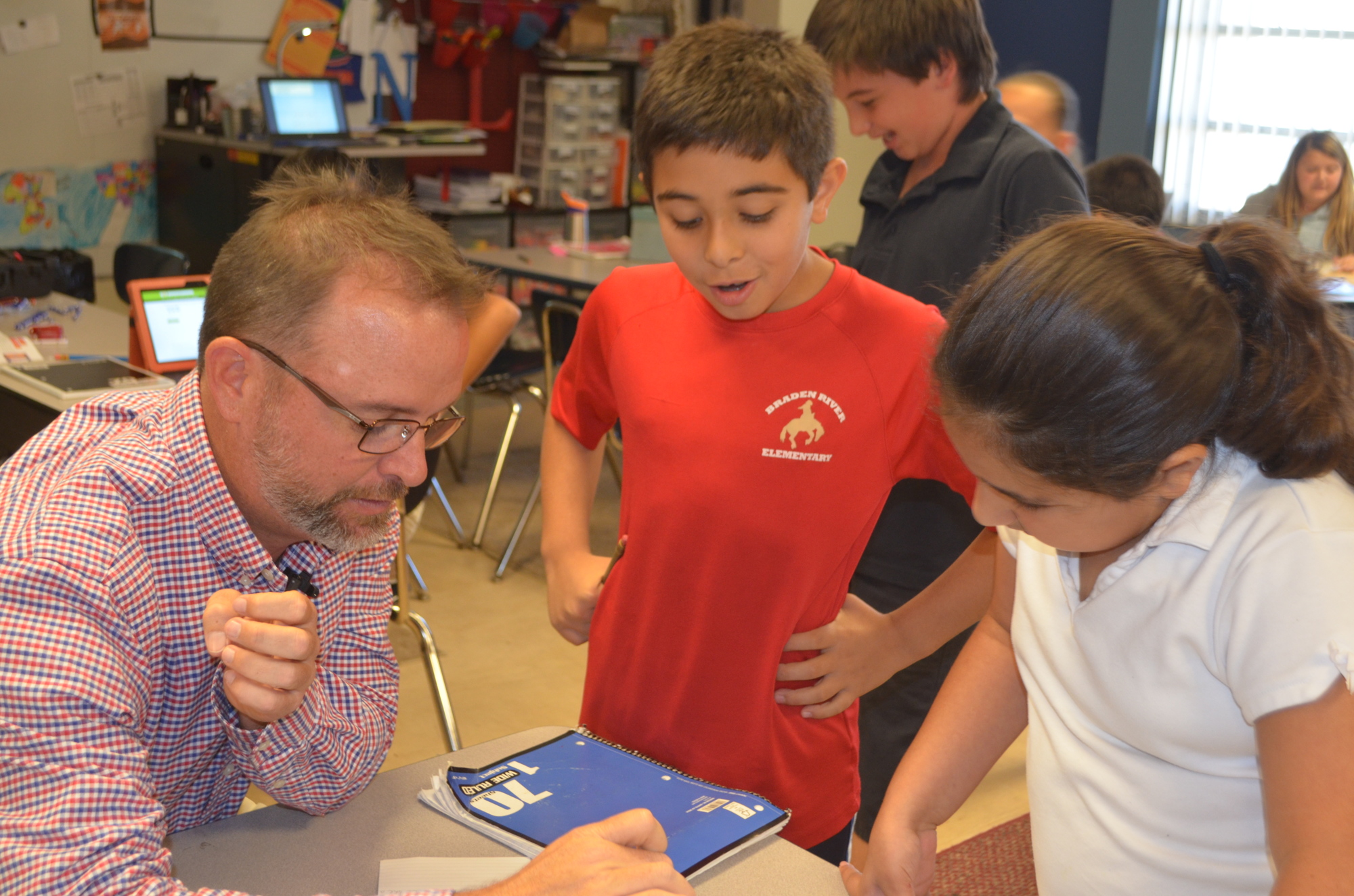 Braden River Elementary School fourth grade teacher Nicholas Leduc helps his students Elias Katra and Parmis Cyrus during “independent time” in class.