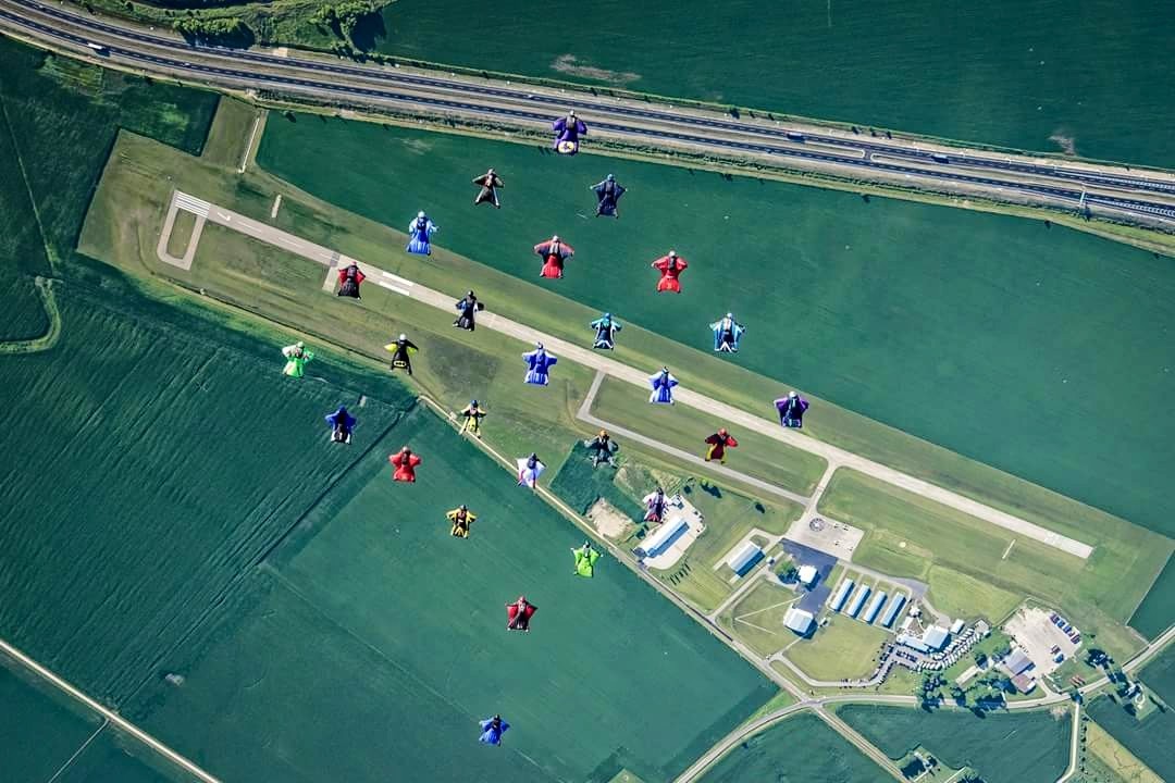 What a wingsuit formation looks like from the aircraft.Left: East County’s Michelle Statdfield holds her Florida record for largest formation for a women’s wingsuit group, which was eight.