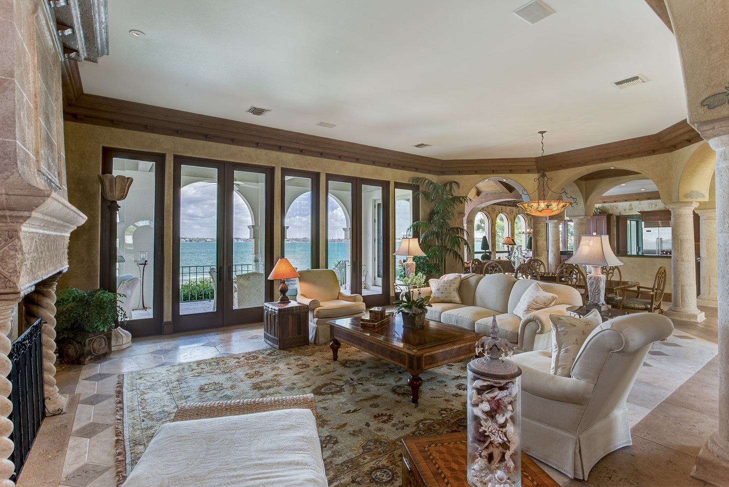 The living room looks out over the Gulf of Mexico.  The estate also features a pool and hot tub with adjoining terraces and courtyards overlooking Sarasota Bay. Photo courtesy of Michael Saunders & Company.