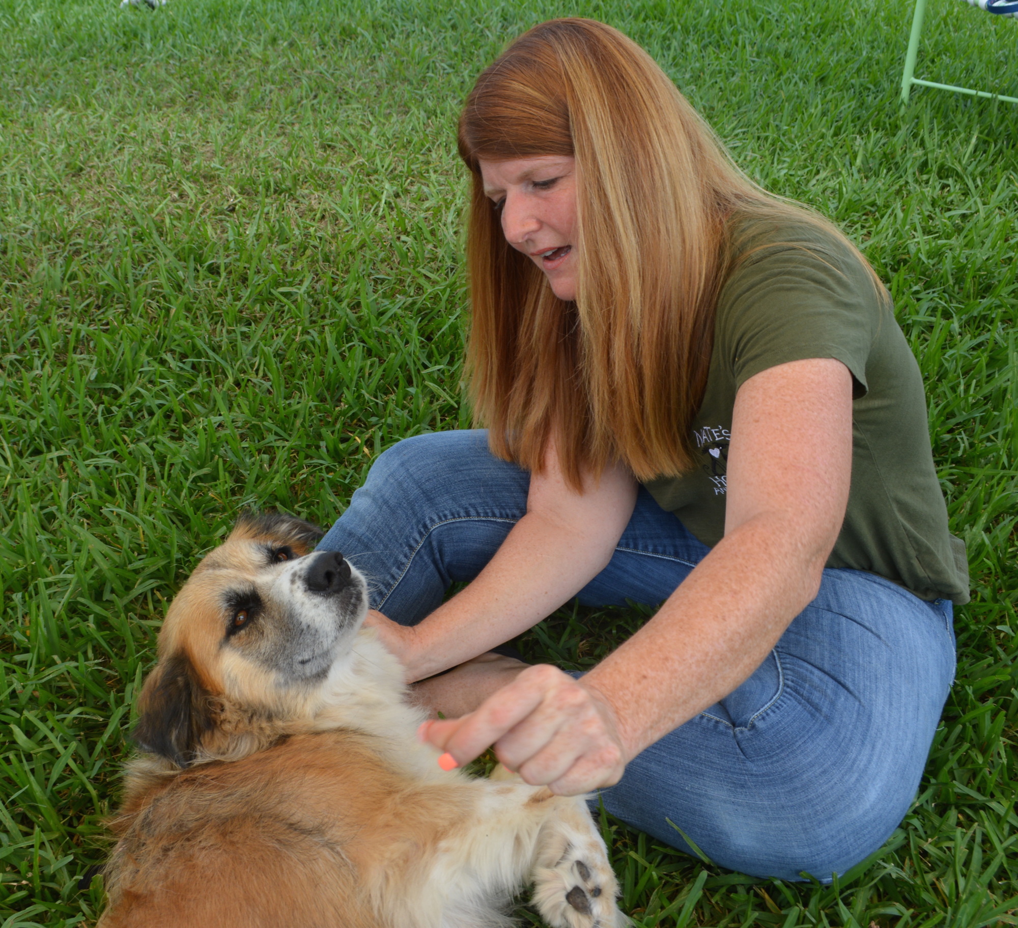 Karen Slomba plays with Saddie, a Great Pyrenees mix, at Nate's Honor Animal Rescue.