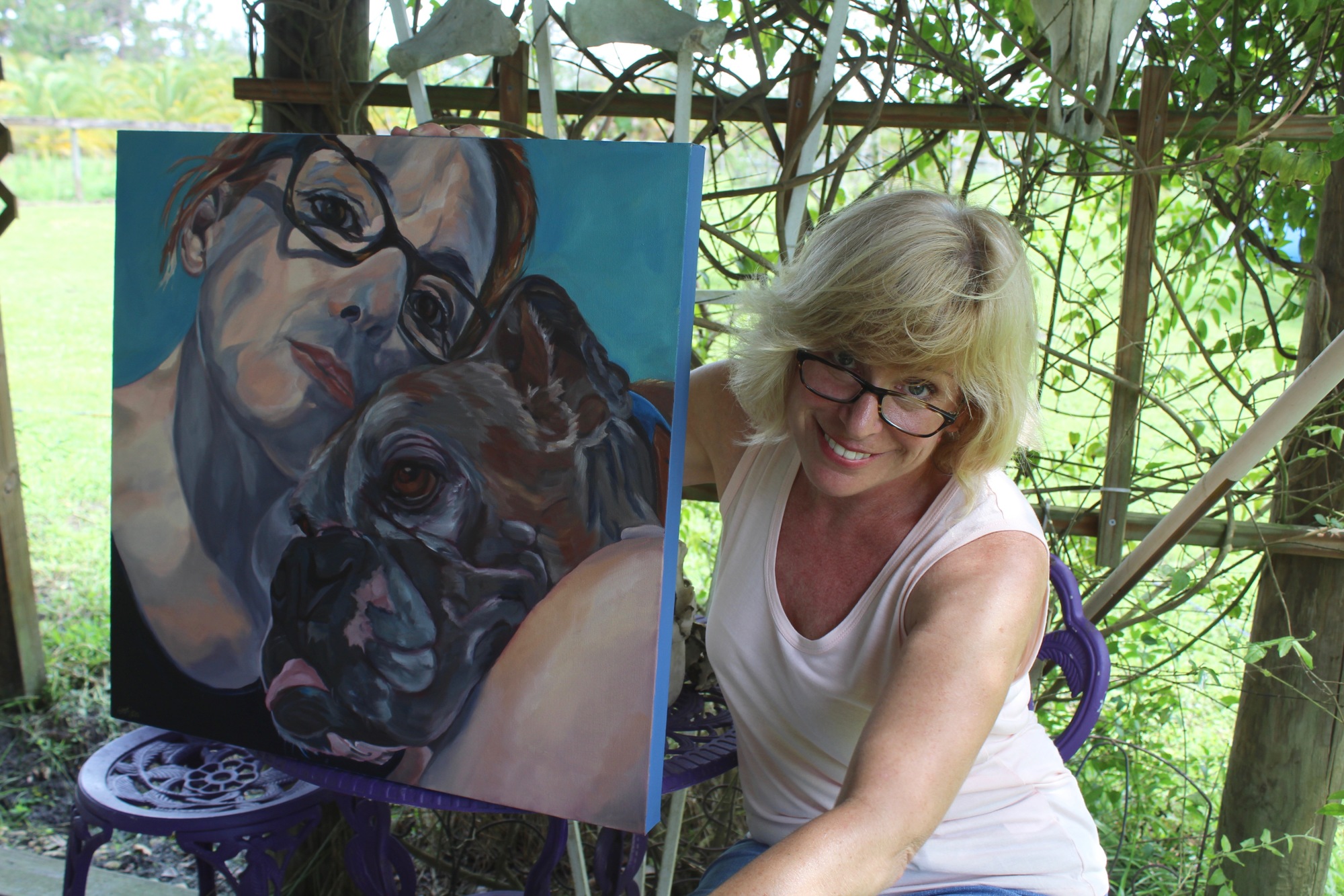 velyn McCorristin Peters holds one of her favorite portraits of her and her dog, Abby, who died years ago.