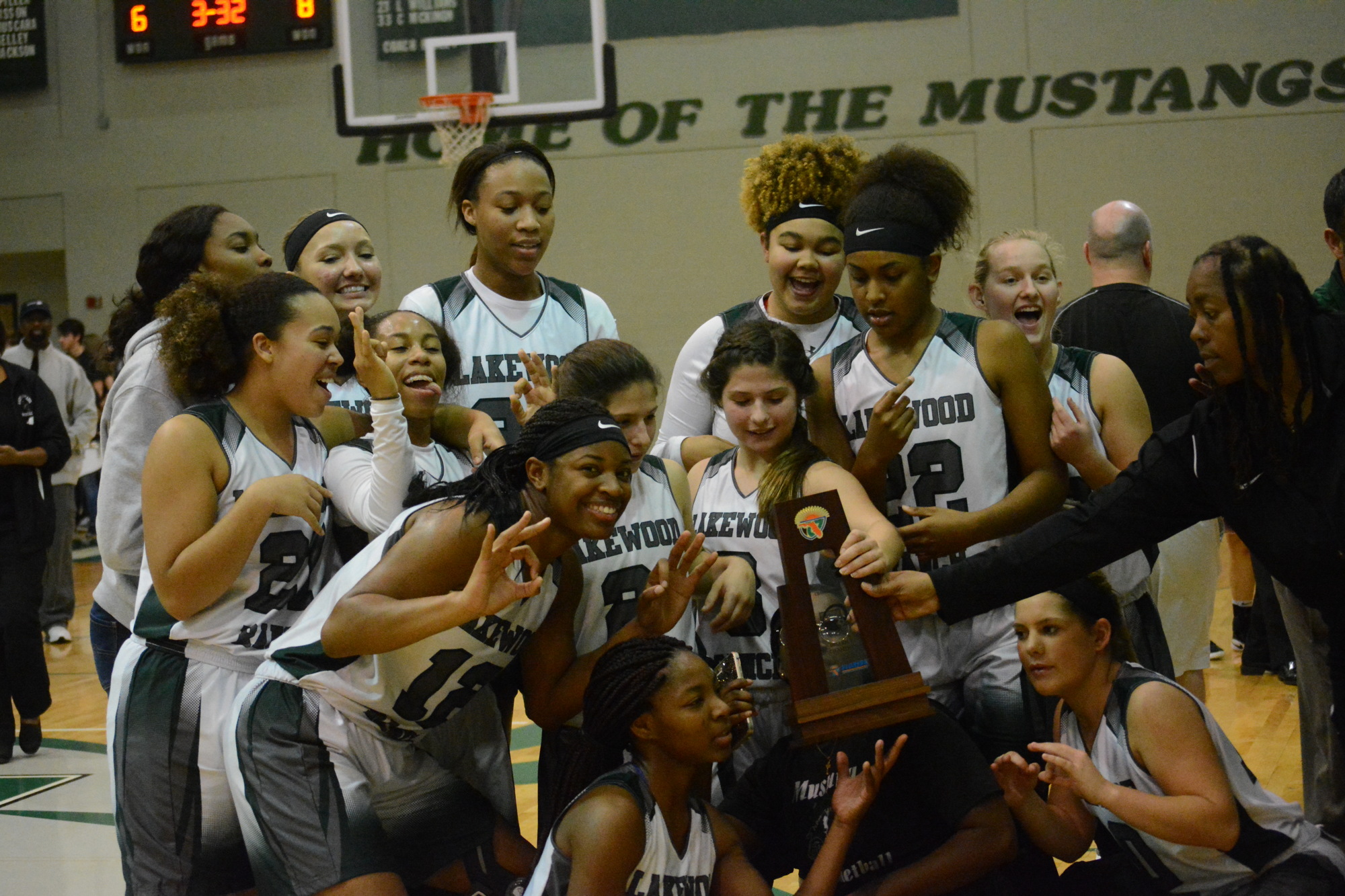 The Mustangs and Tina Hadley celebrate their 2017 district title.