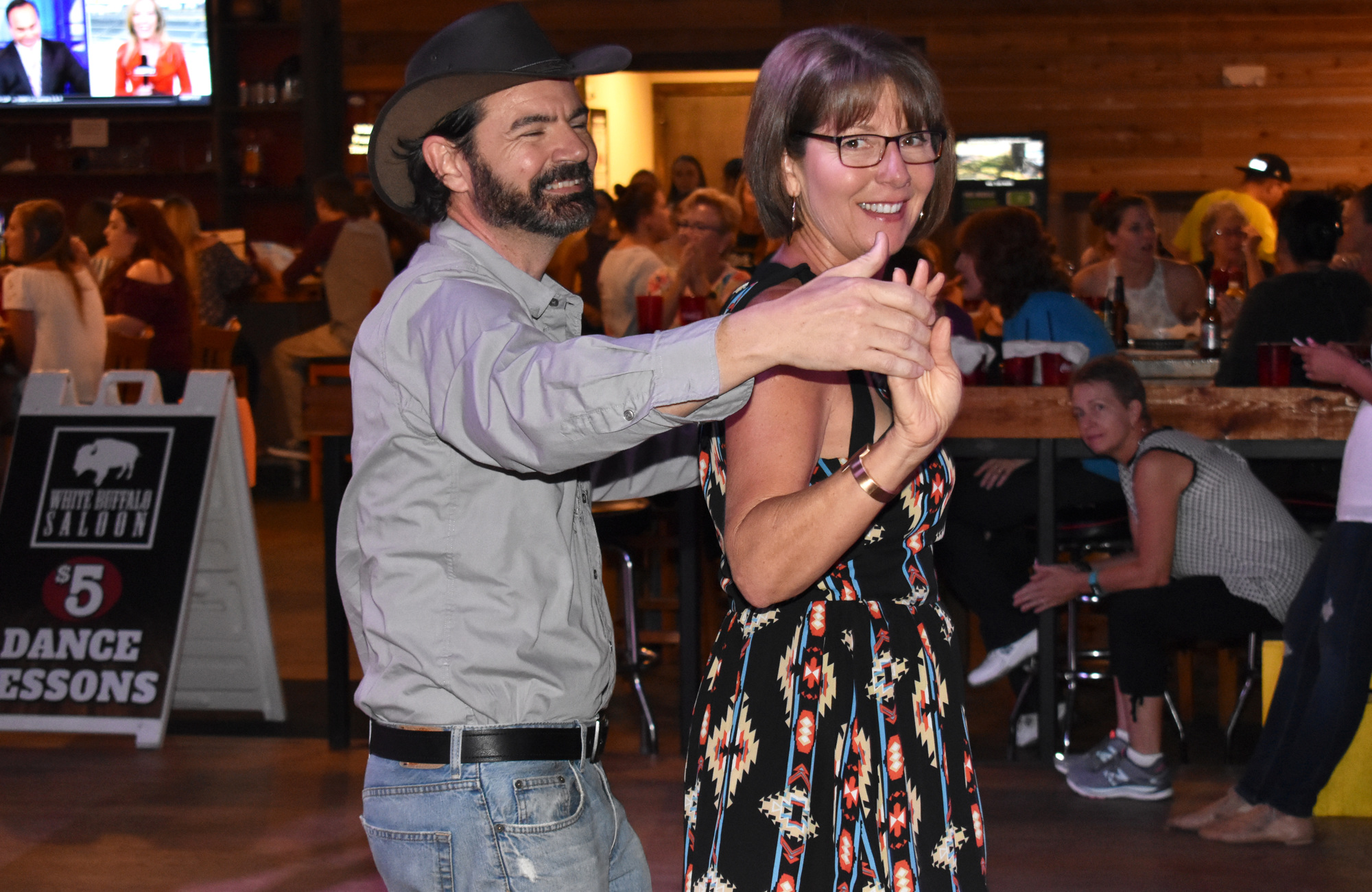 Many regulars like Michael Raimondi and Adria Stasko participate in both line dancing and partner dancing, the latter of which is done by circling the line dancers in the middle of the dance floor. Photo by Niki Kottmann