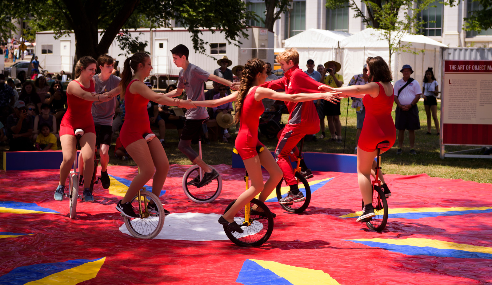 Sailor Circus performers do a unicycle demonstration on June 29 on the National Mall at the Smithsonian Folklife Festival. Photo by Cliff Roles
