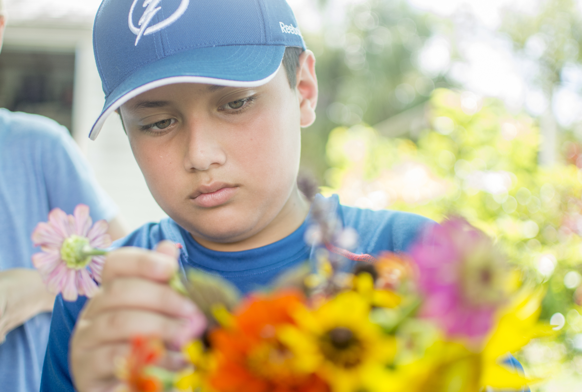 Jacob Lirio makes a flower bouquet out of the flowers picked from Hershorin Schiff Community Day School's garden.