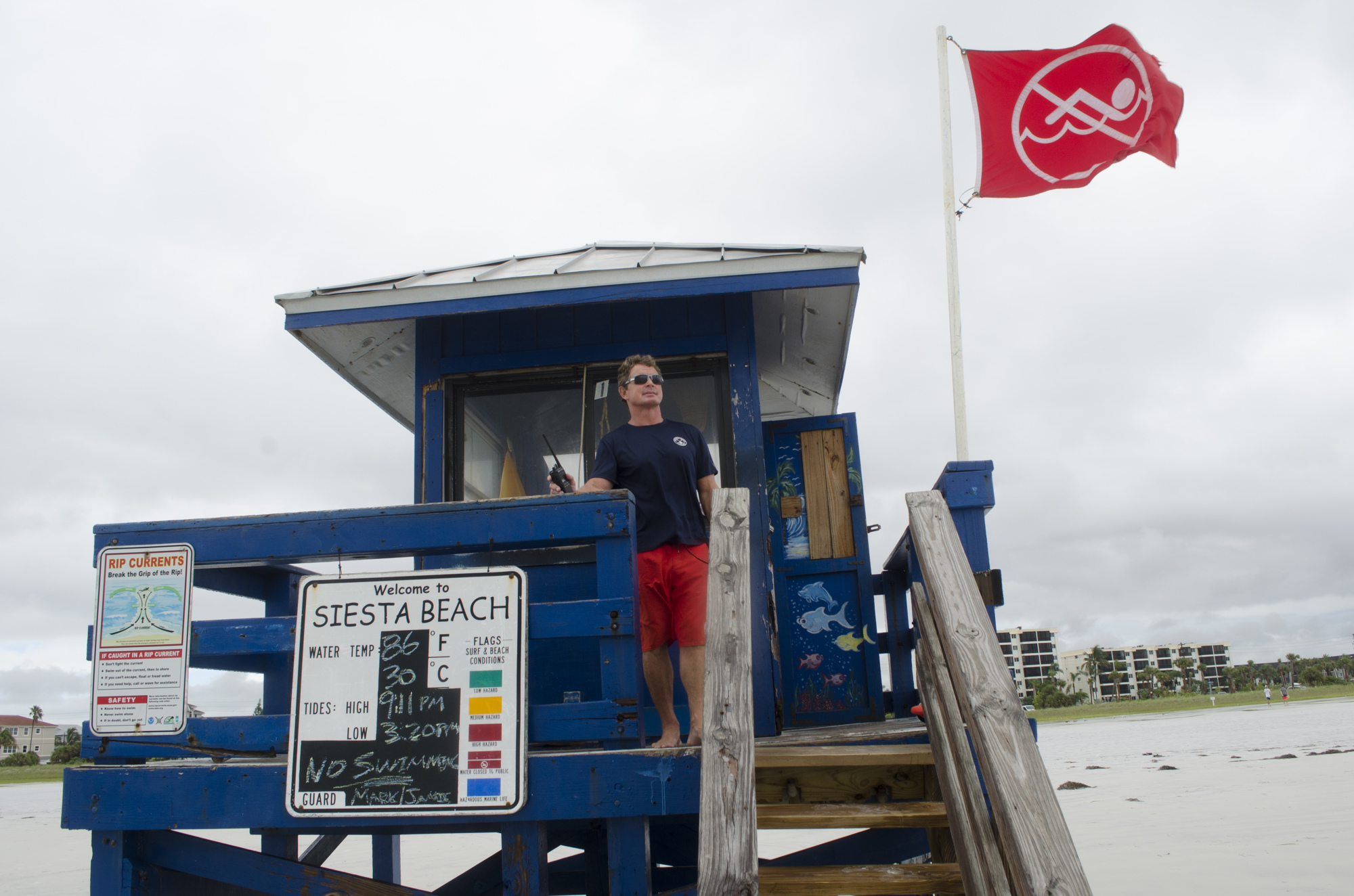 Mark Miller watches over beachgoers to be sure they don't go to far in the water while the no-swim flags are out.