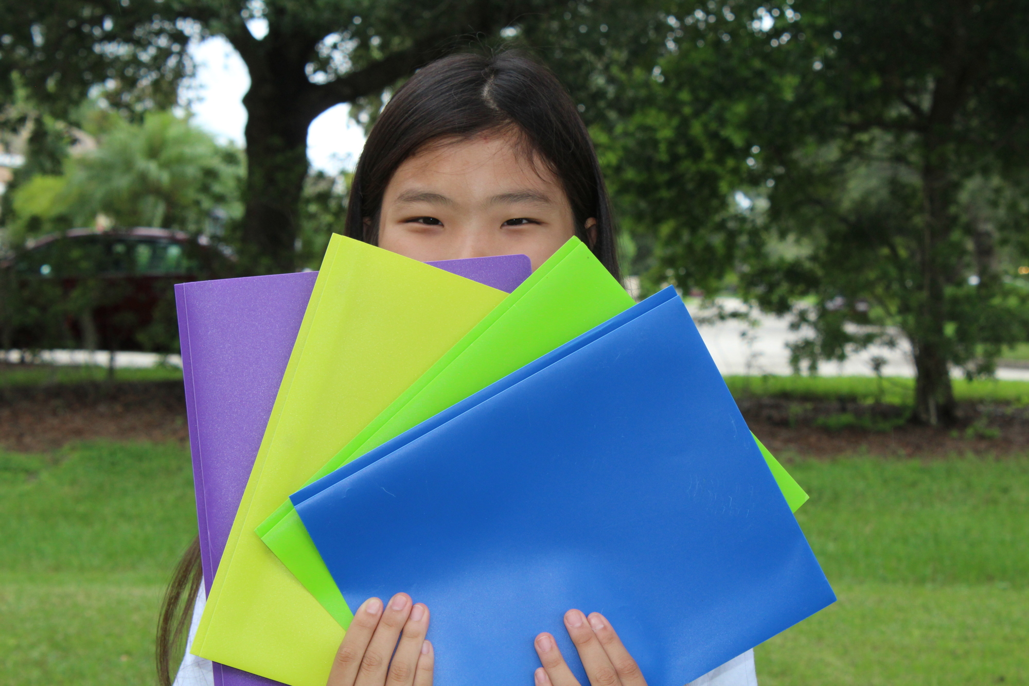 Braden River Middle School sixth-grader Hope Tudor shows off her colorful collection of pocket folders.