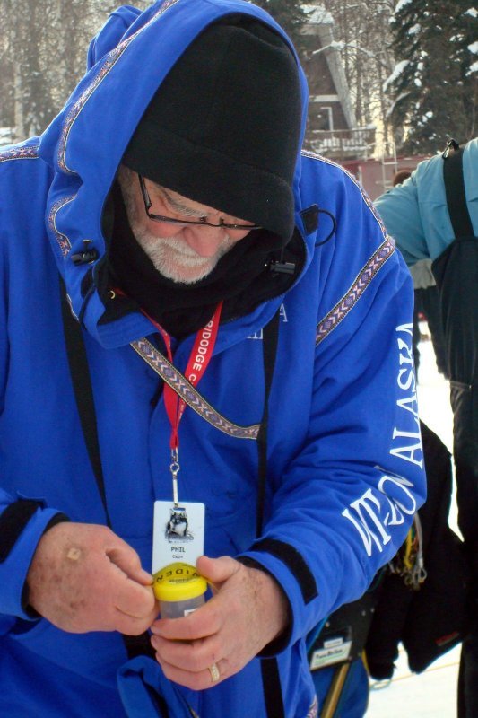 Phil Cady labels a dog's urine sample during one of the many Iditarod races he's volunteered for. Courtesy photo