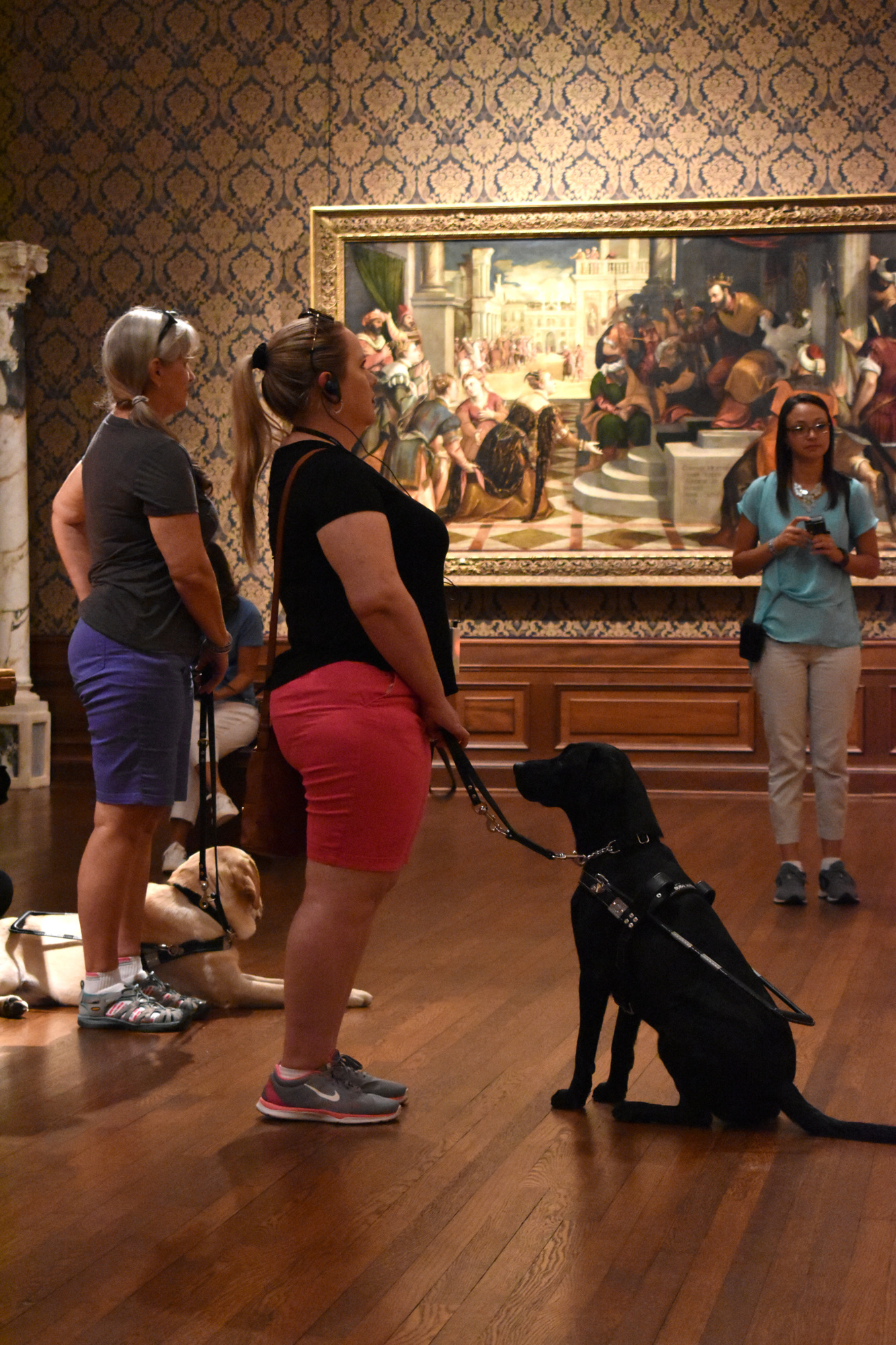 Nancy Gaspar listens to the tour as her 22-month-old guide dog Marisa tries to get her attention. Photo by Niki Kottmann