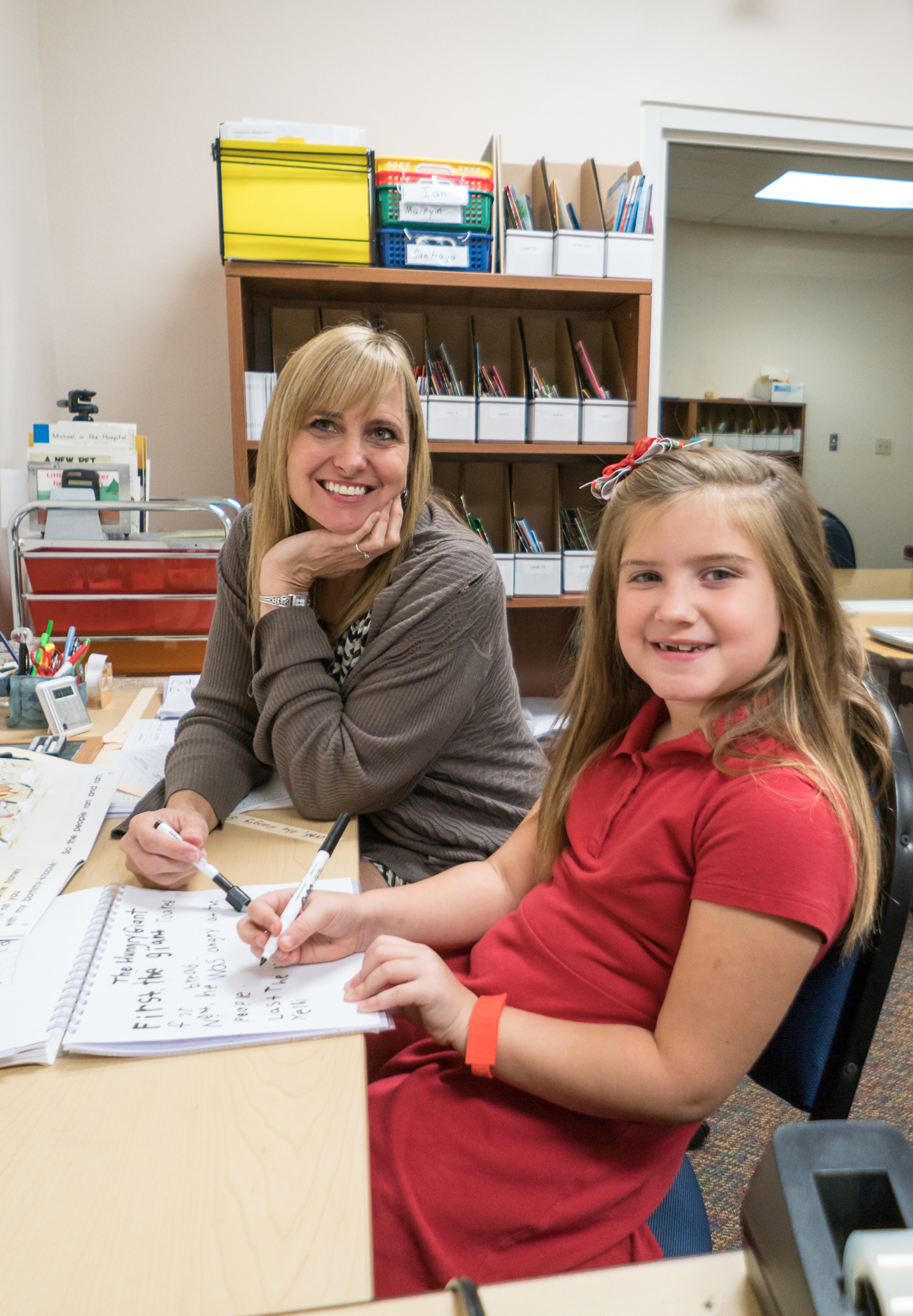 Lisa Fisher works with a student in the reading recovery program, which helps at-risk first graders catch up to their peers. Photo courtesy Gulf Coast Community Foundation.