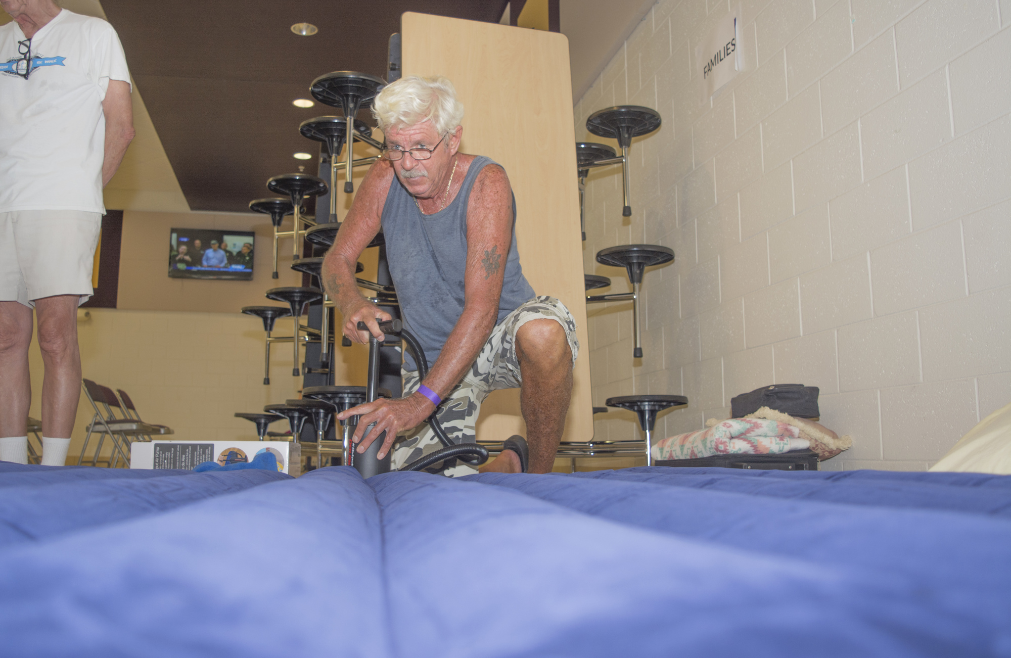 Dave Norrgard pumps up an air mattress in preparation for a night at the shelter.