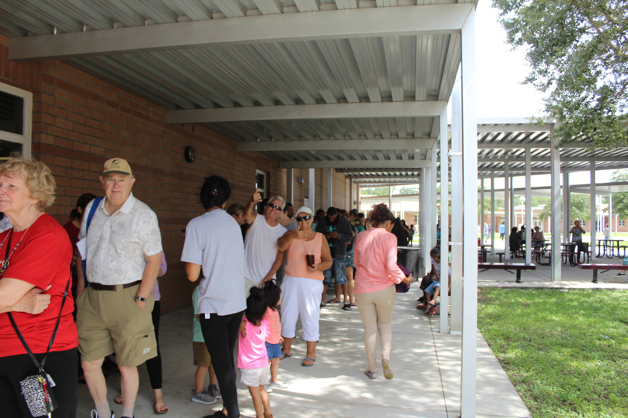 A line of evacuees wait for food at the Braden River High School emergency shelter.