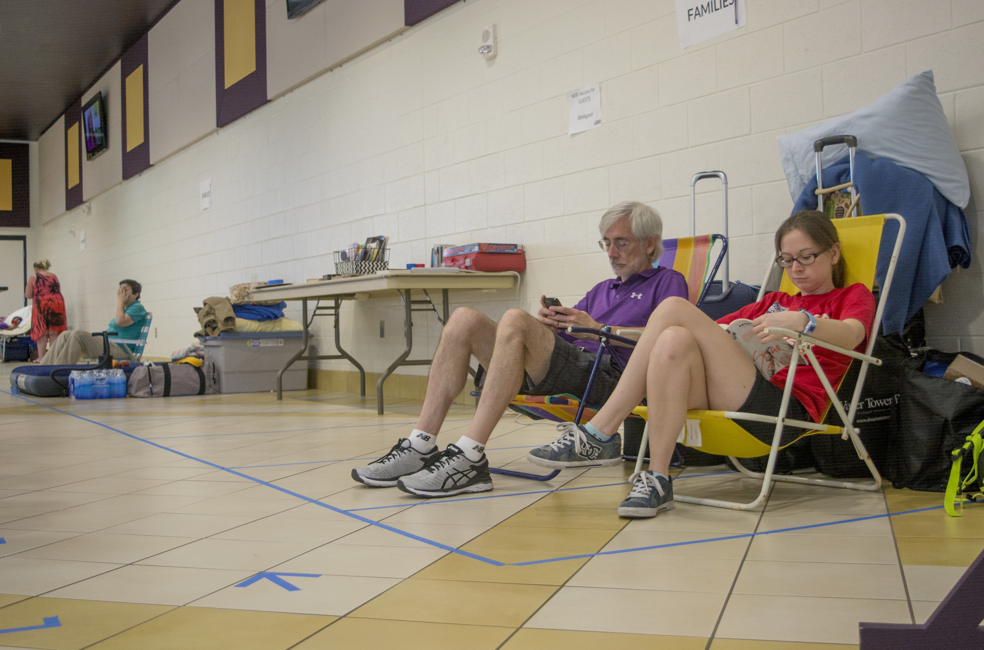Jerry and Sarah Gumbleton sit in the Booker High School cafeteria on Friday afternoon. The shelter reached capacity Saturday morning.