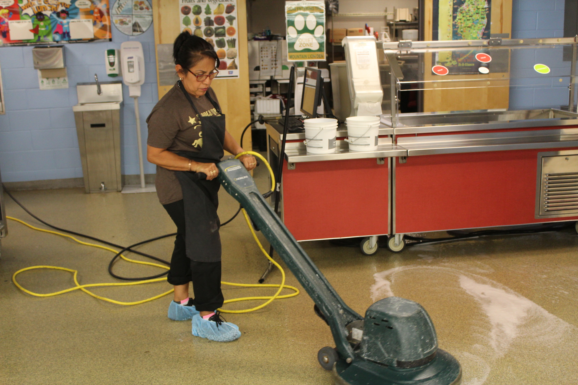 Virgil Mills Elementary served as a shelter during Hurricane Irma. School Assistant Cafeteria Manager Adela Garza cleaned the floors after evacuees returned home.