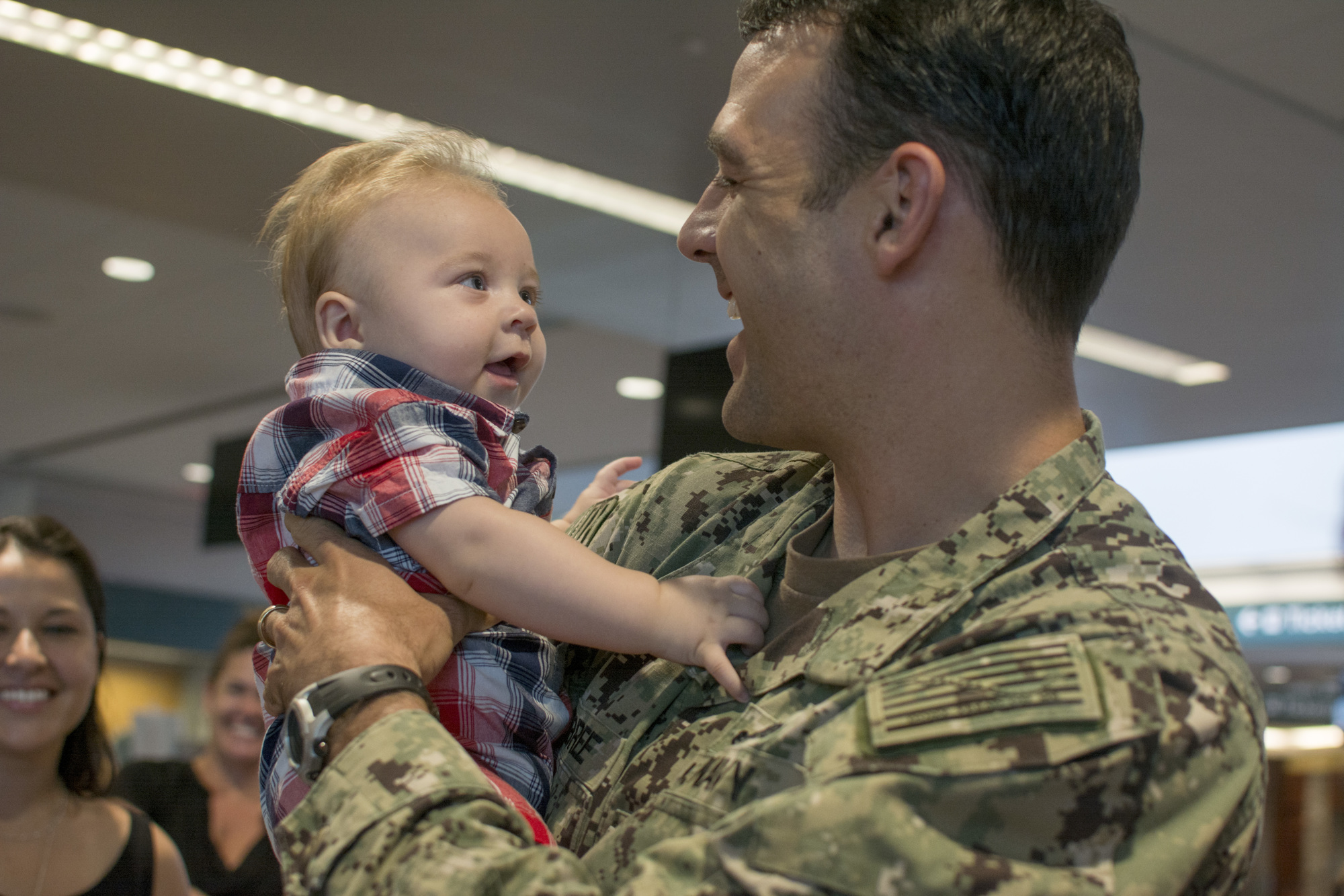 Commander Joe Hembree holds son Jacob Hembree after returning home from a more than one year long deployment in Djibouti.