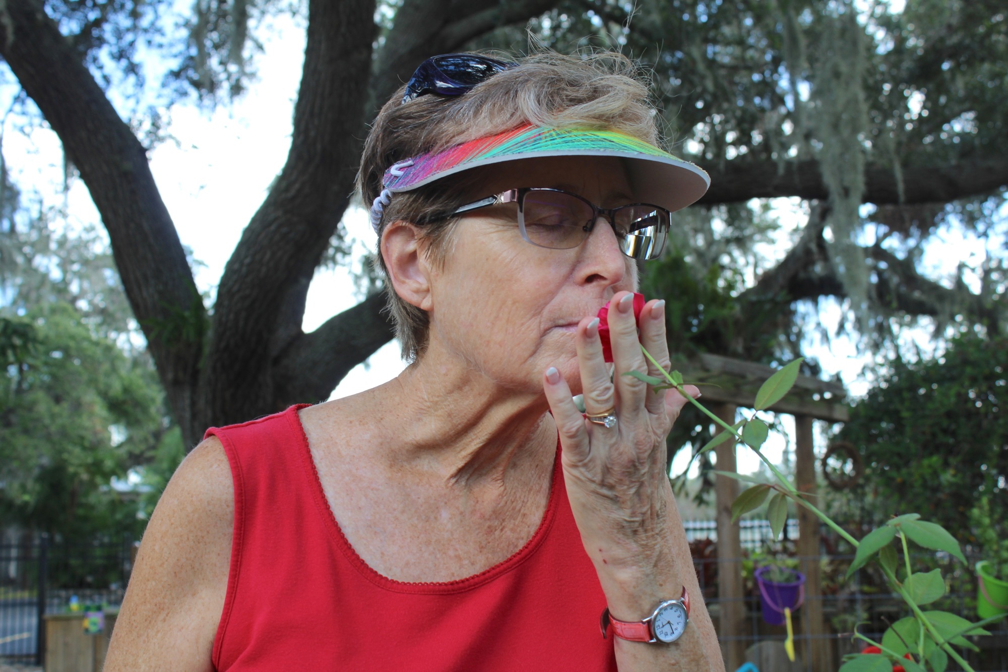 Lori Walker, president of the Lakewood Ranch Garden Club smells a fresh rose at an educational garden in Palmetto.