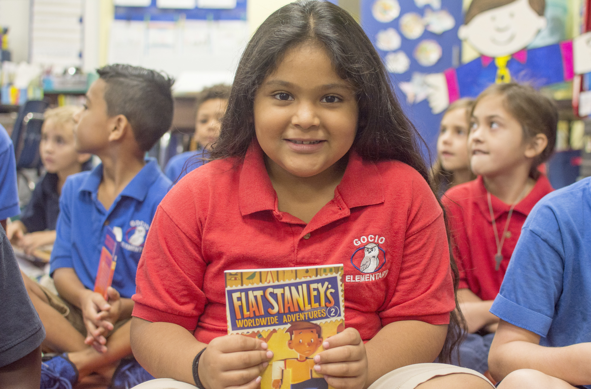 Ruby Guel shows off her copy of “Flat Stanley’s Worldwide Adventures.”