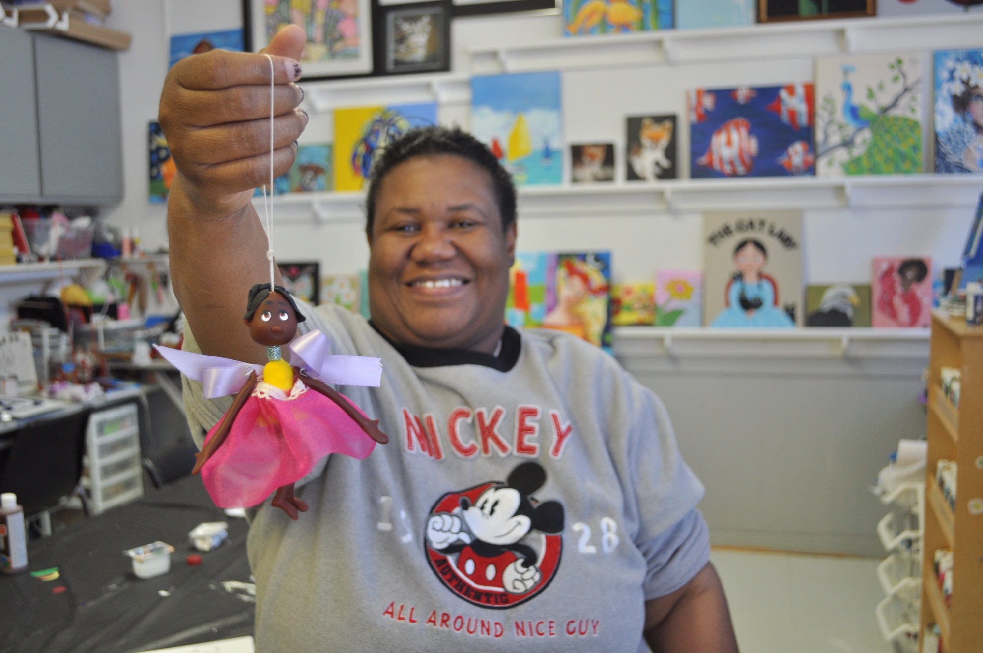 Easter Seals artist Patty, who is deaf, holds up one of the ornaments she recently created.