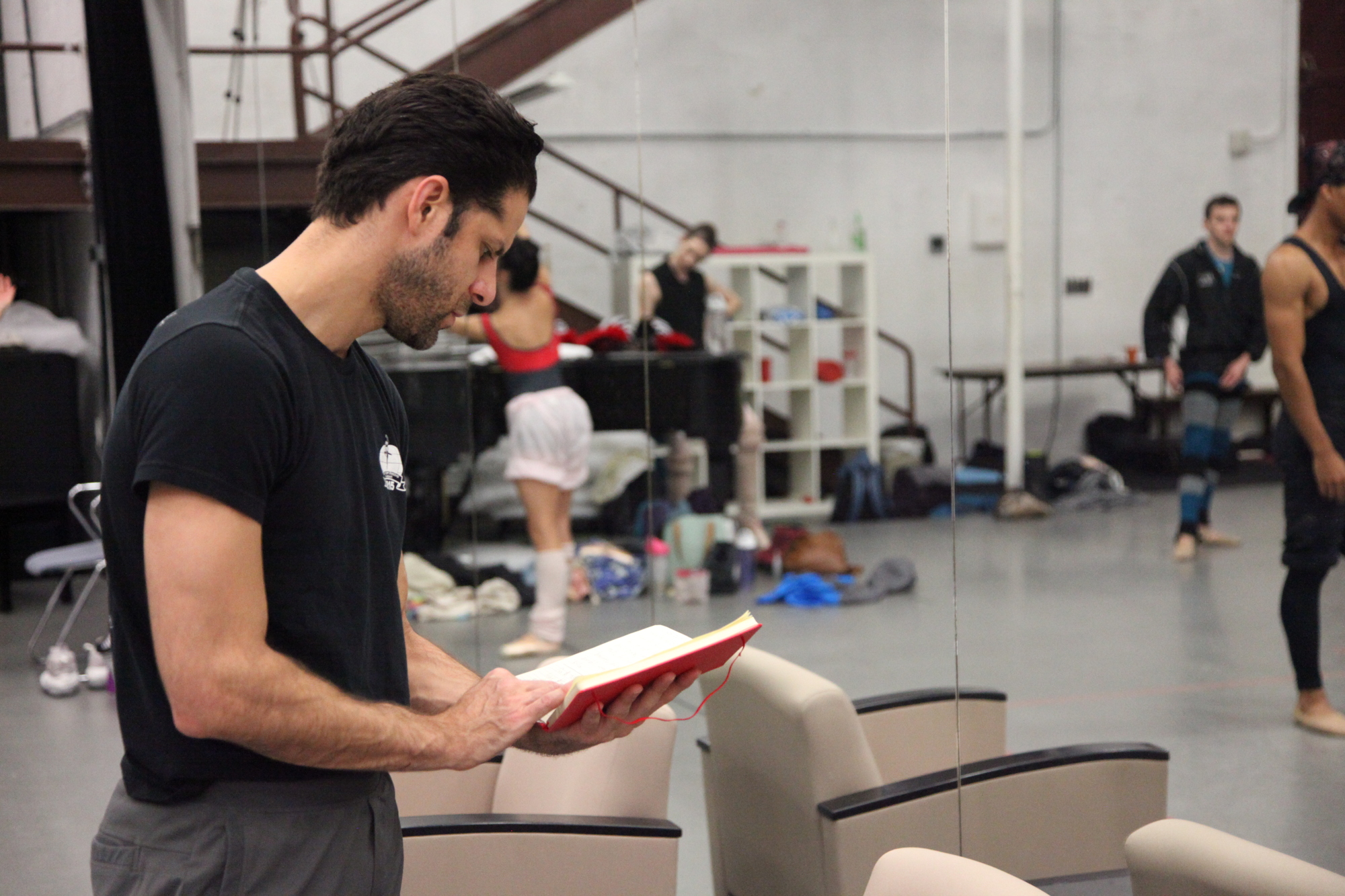 Choreographer Marcelo Gomes checks his notes during rehearsal with The Sarasota Ballet for his piece, 