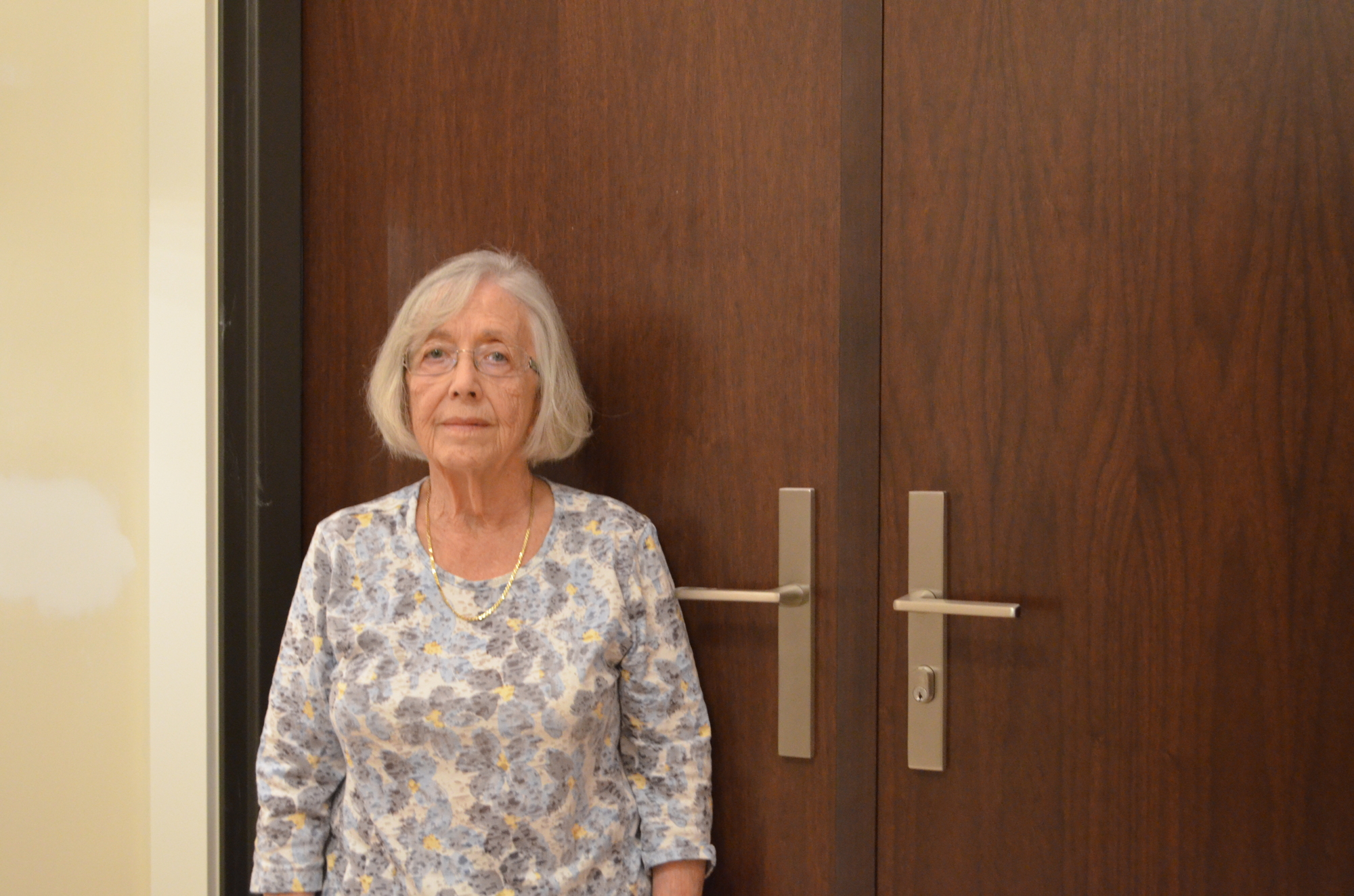 Shirley Deutsch's new door handle is nearly 45 inches high,  reaching to the top of her shoulder.