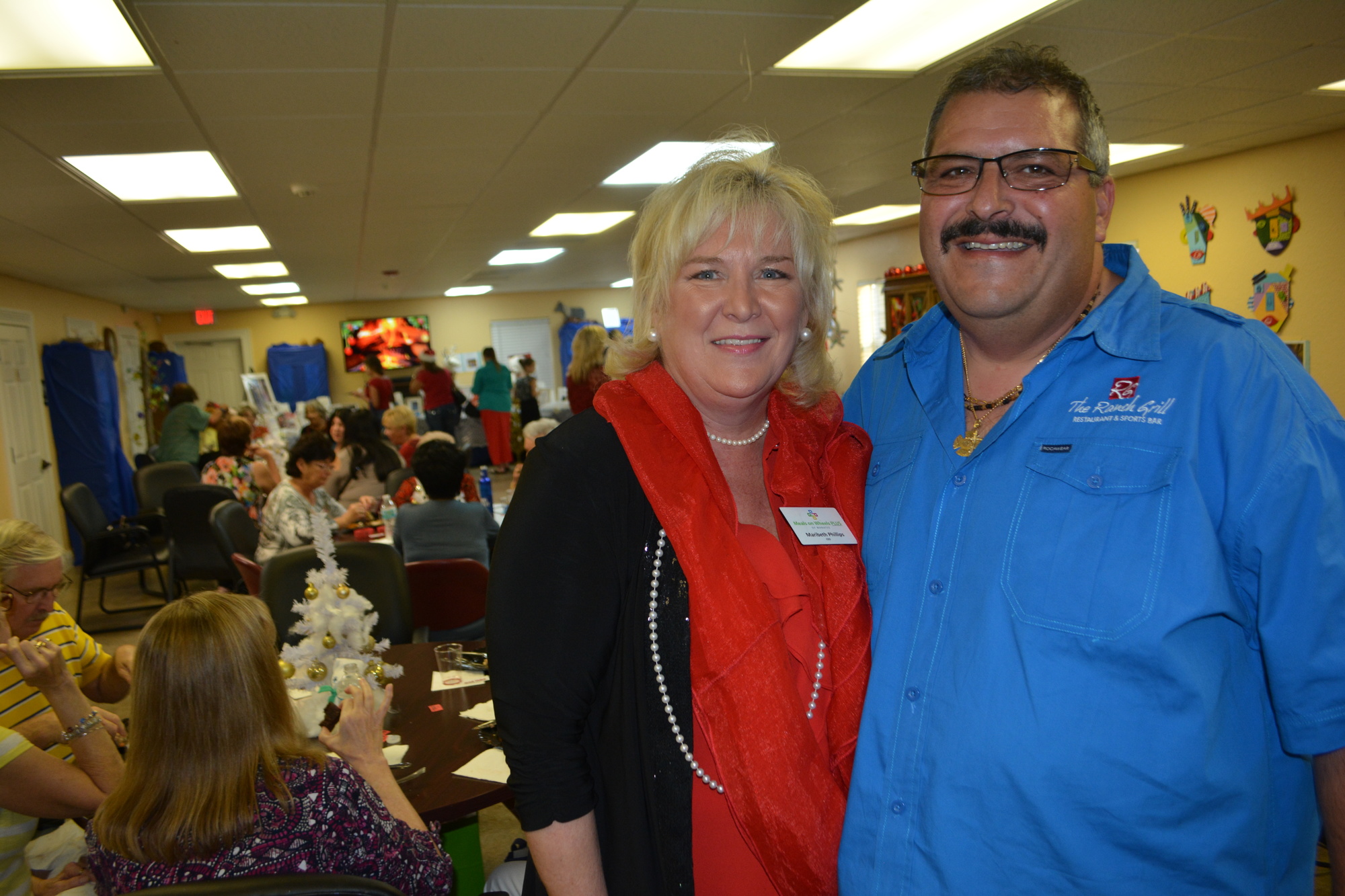 Meals on Wheels Plus CEO Maribeth Phillips and Ranch Grill owner Darrin Simone enjoy the Shoe Box Reception and Holiday Mart.