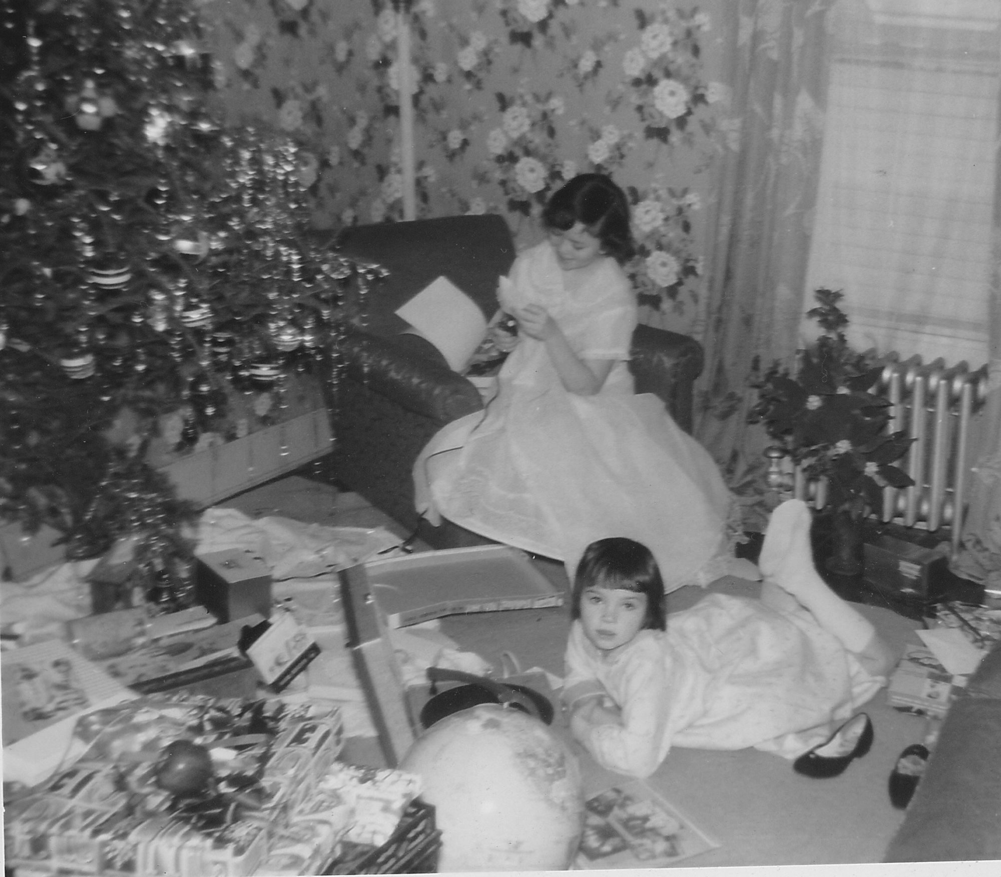 Mote Ranch's Meg Garo, front, looks at presents the year Santa was running late. Her older sister, Maryellen, is also pictured. Courtesy photo.
