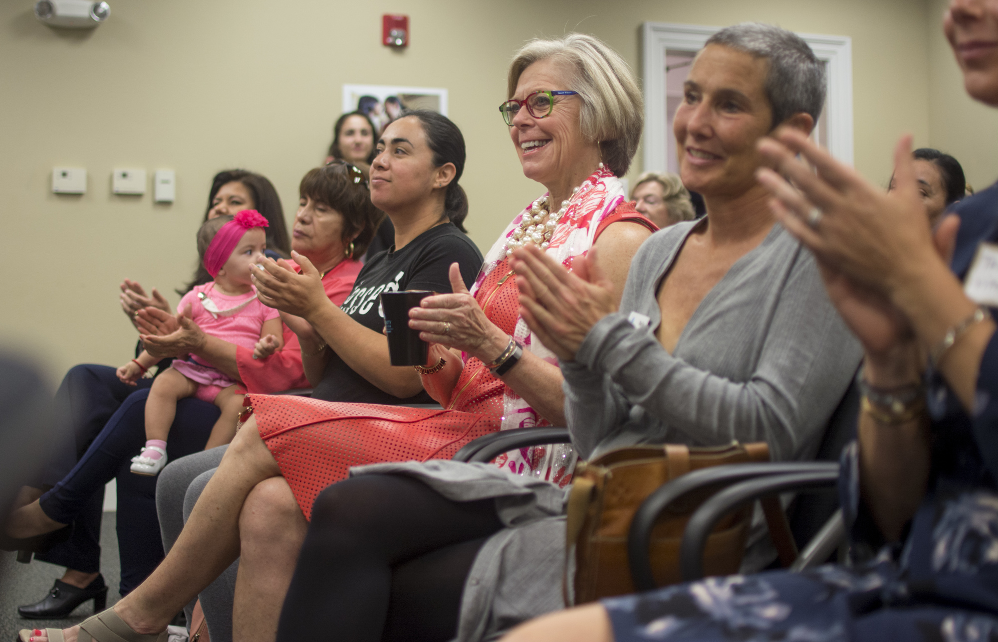 Community Foundation of Sarasota County President and CEO Roxie Jerde applauds after listening to UnidosNow Executive Director Luz Corcuera speak at the Community Foundation of Sarasota County on Dec. 6.