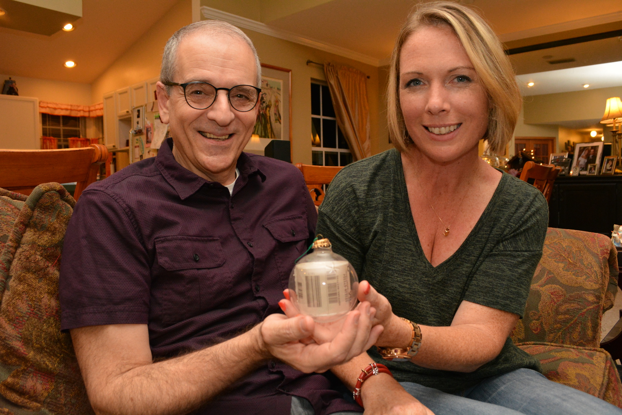 Tony Dertouzos and his wife, Amity Hoffman, say the baggage tag inside this ornament originally looked like a cigarette because it was rolled so tightly to fit inside. Over time, it has expanded. Photo by Pam Eubanks.