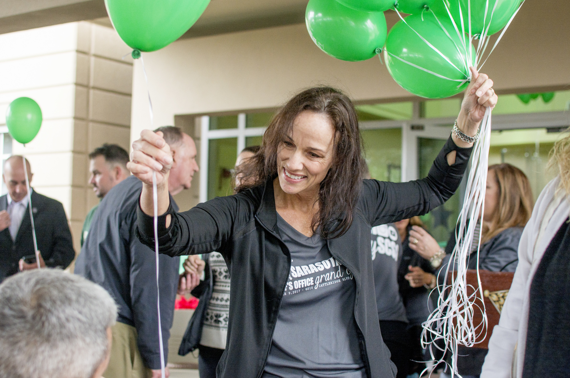 Penny Johanesen passes out balloons during the ribbon cutting celebration.