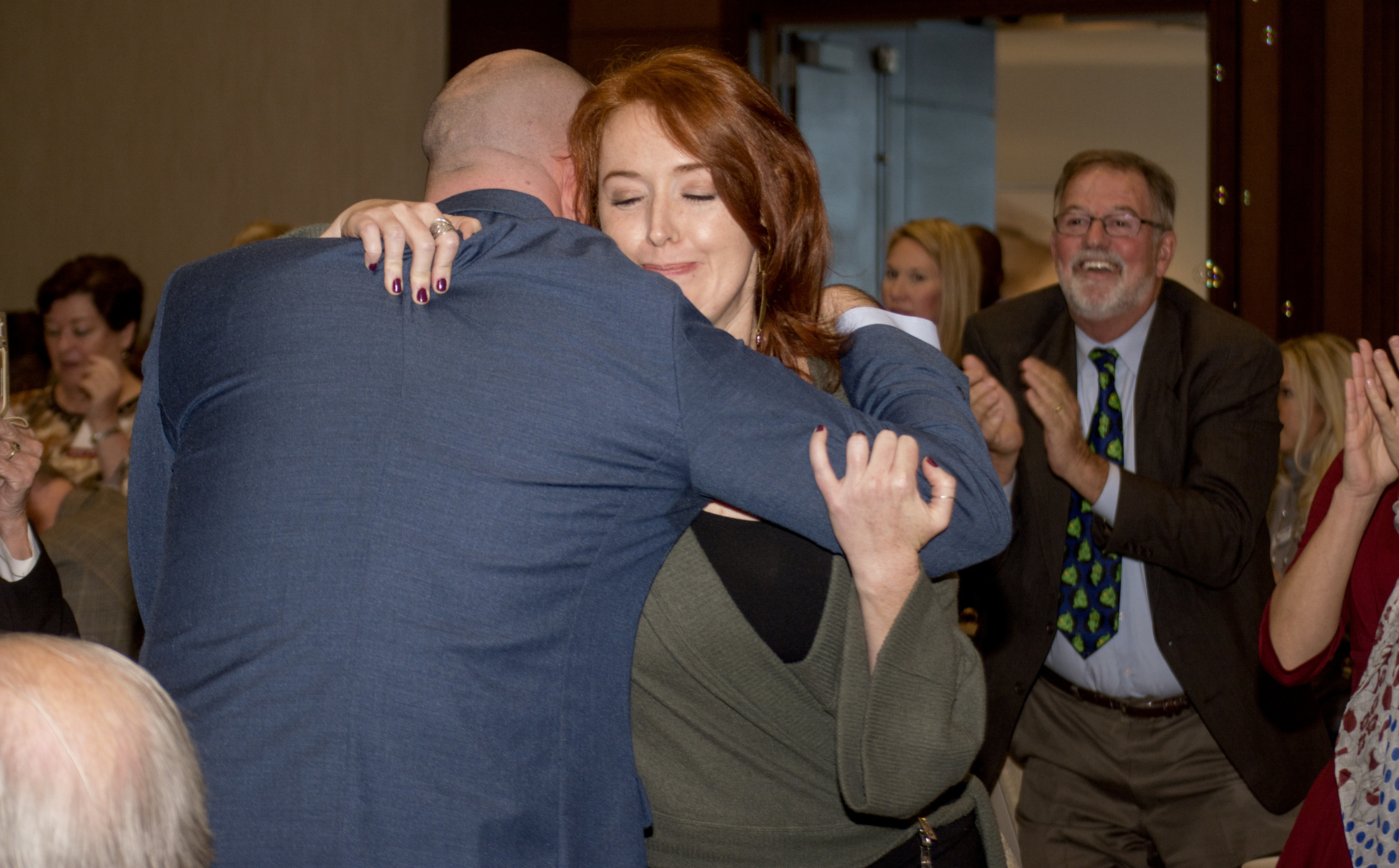 Es Swihart hugs the 2017 Teacher of the Year and fellow Riverview High School teacher William 