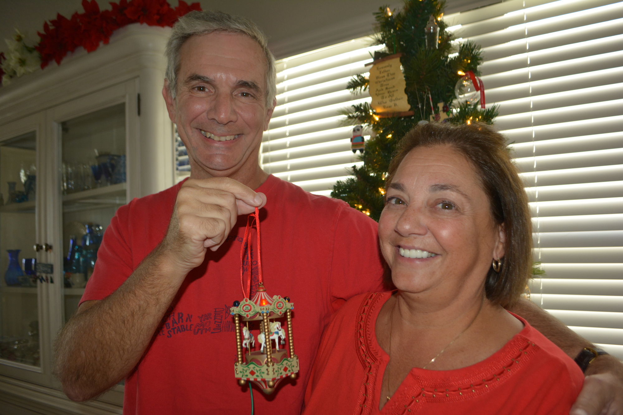 Greg and Denise Tanno of Indigo show off the ornament that represents the carousel where they first met 30 years ago. Photo by Jay Heater