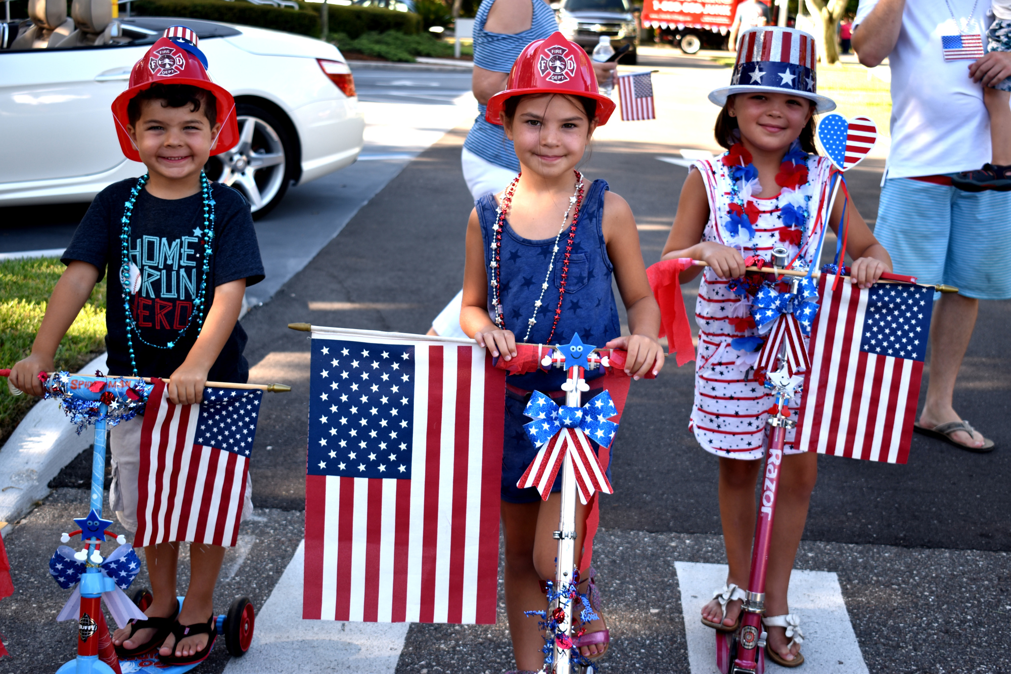 Zach, Lyla and Brooke Raimonde get ready to ride their bikes in the 2017 Freedom Fest parade.