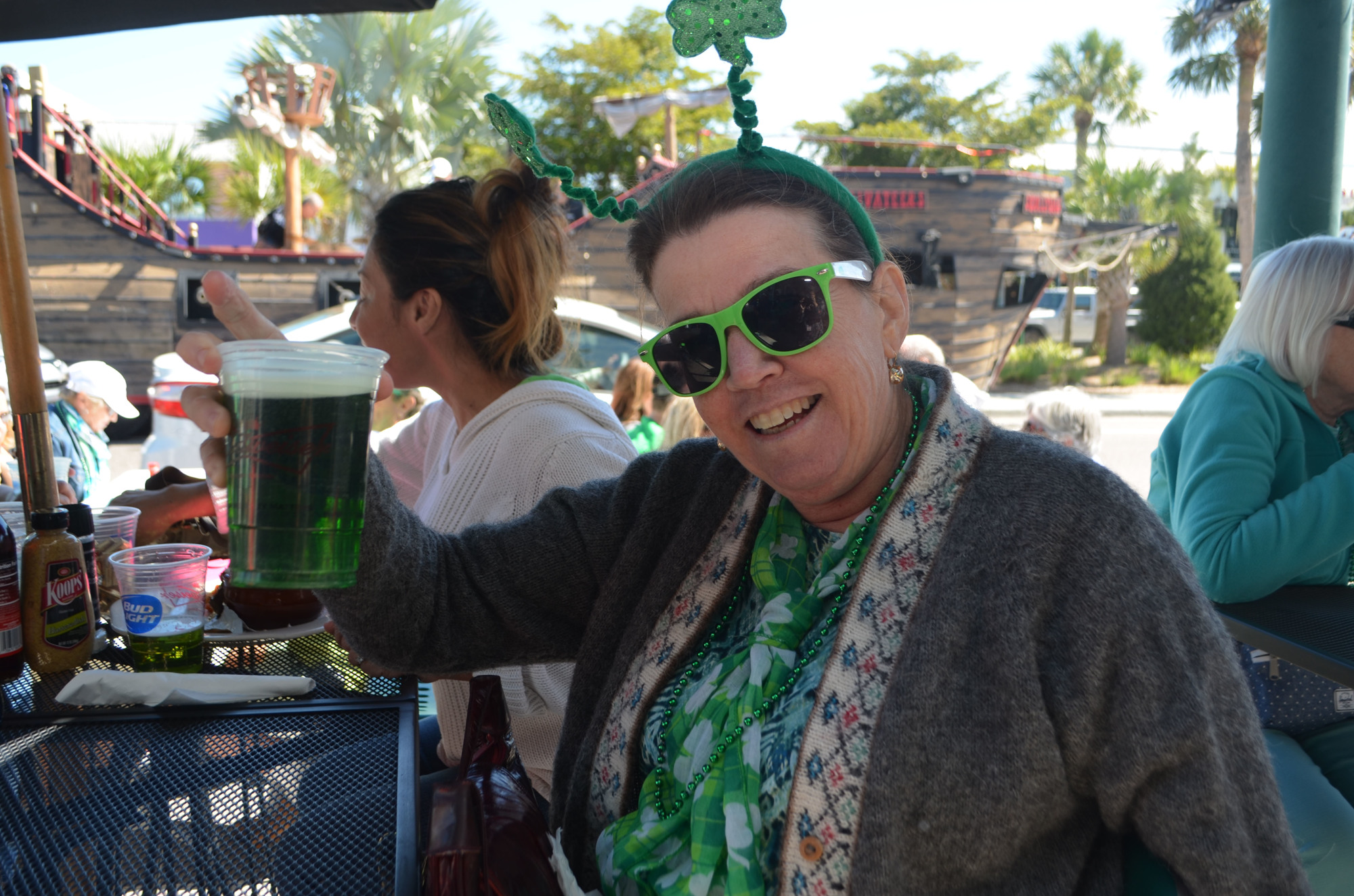 Linda Mercurio holds up her green beer at Lynche's 2017 St. Patrick's Day celebration.