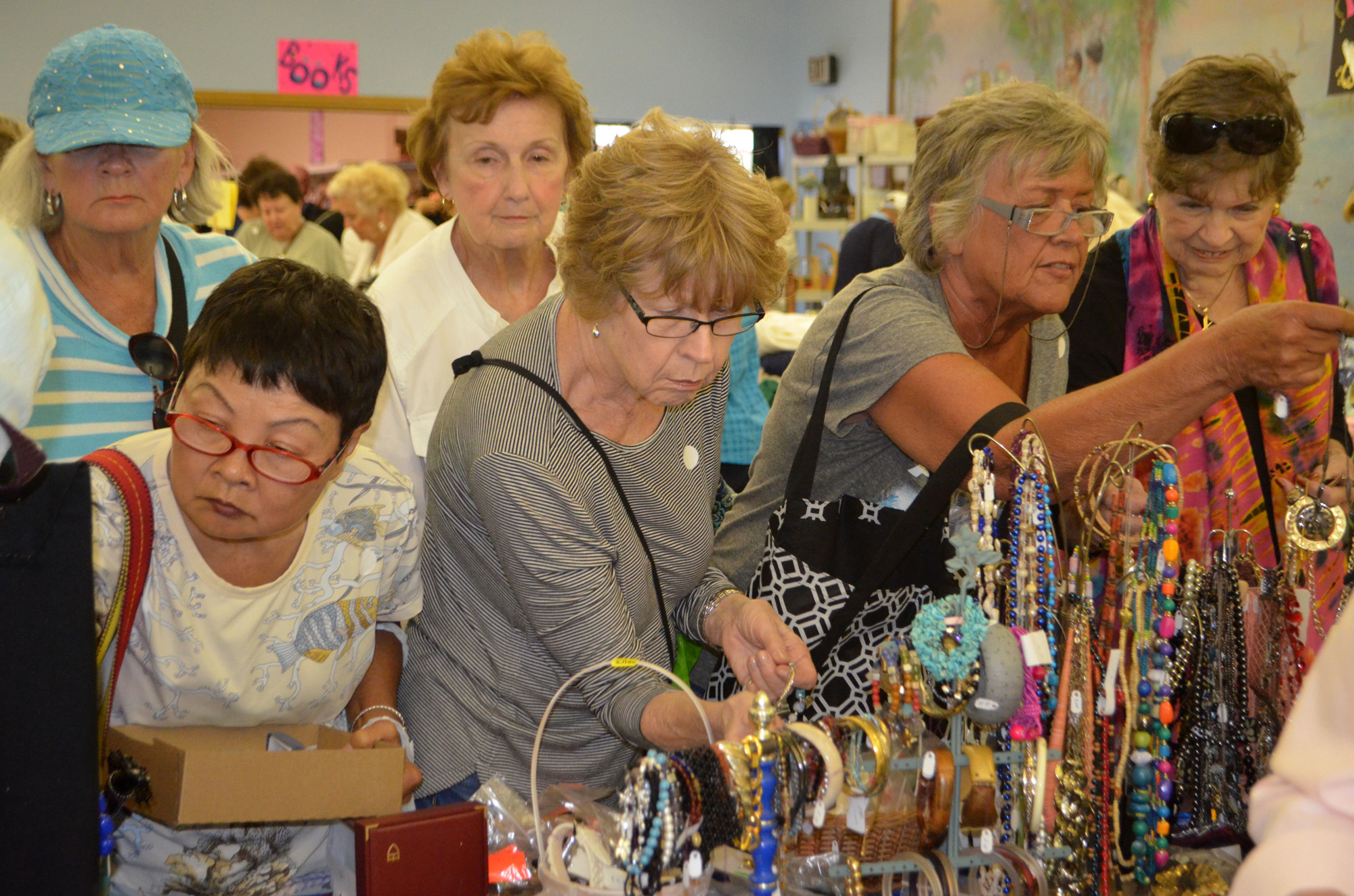 Ladies shop at the jewelry table at the 2017 Royal Rummage Sale.