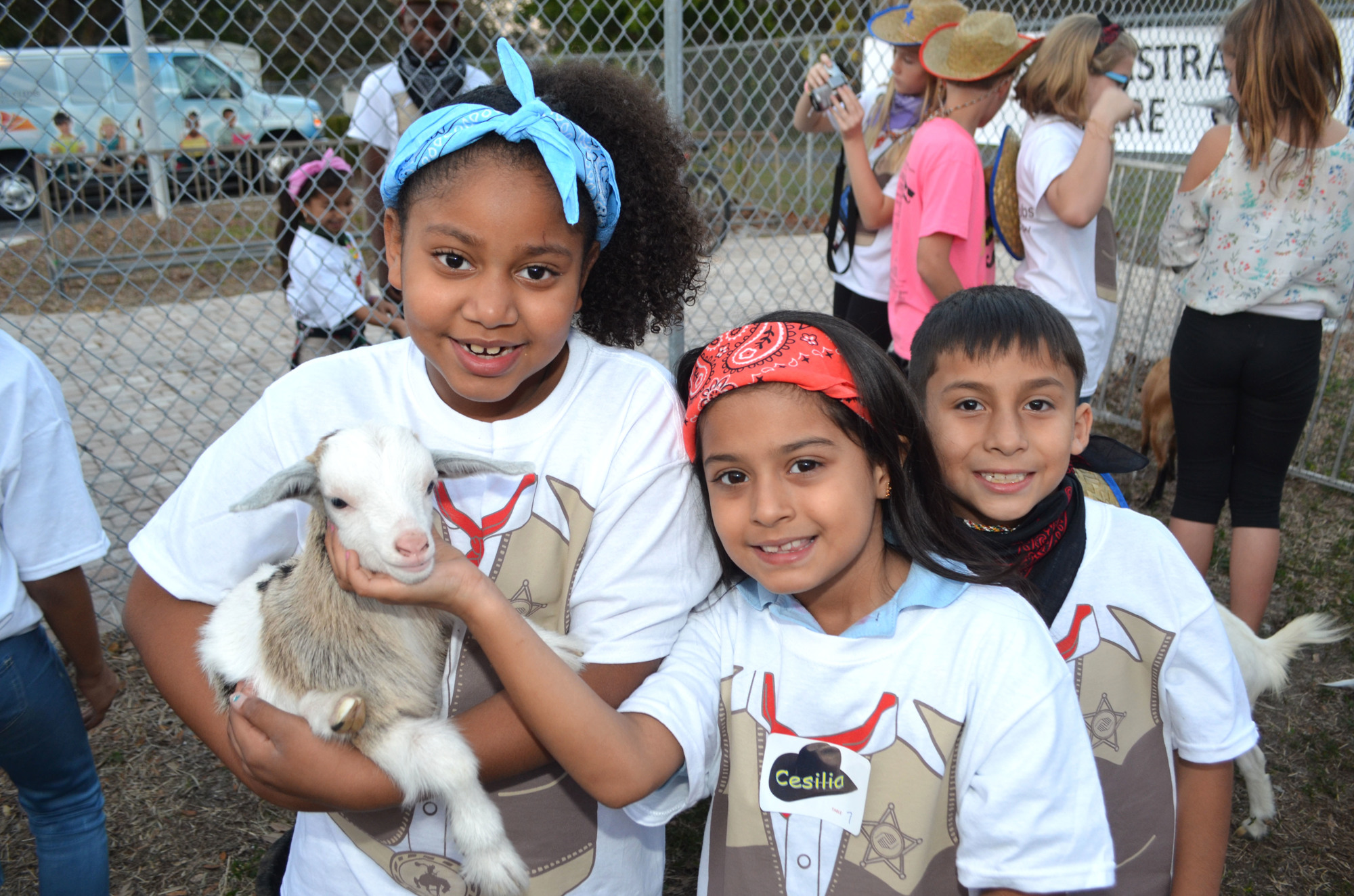 Ariana A., Ayden M. and Cesilla P. get to know a baby goat up close and personal at Steak & Burger Feb. 3, 2017.  Photo by Niki Kottmann