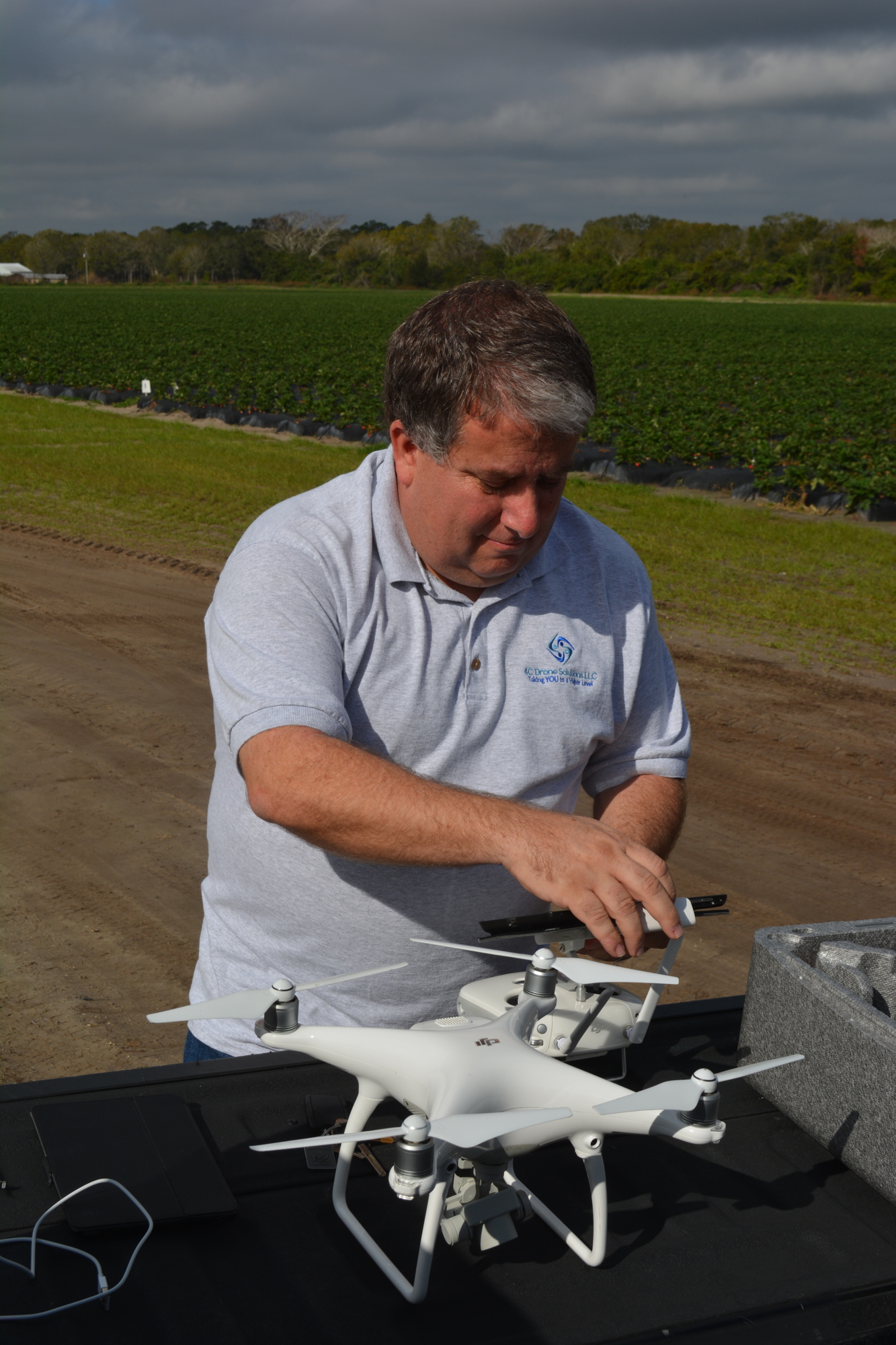 Chad Cox programs his software to fly a drone over O'Brien Family Farms.