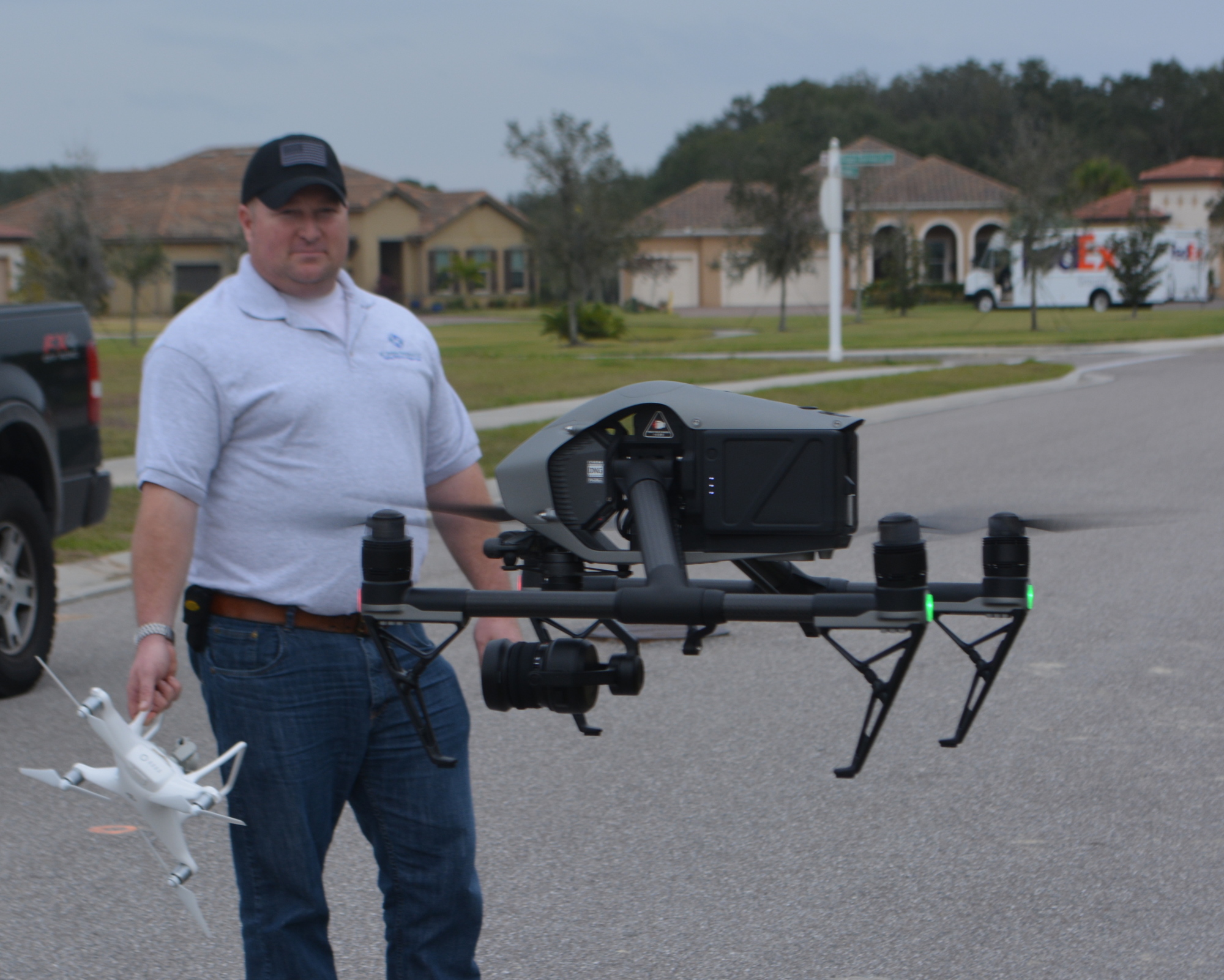 C.J. Carlock watches his partner, Chad Cox, demonstrate the flying capabilities of a drone.