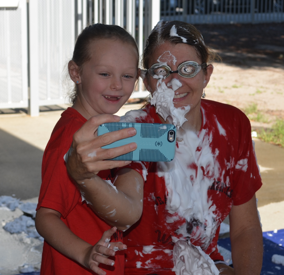 Braden River Elementary Principal Hayley Rio and student Lily Harris take a selfie after a shaving cream pie throwing event.