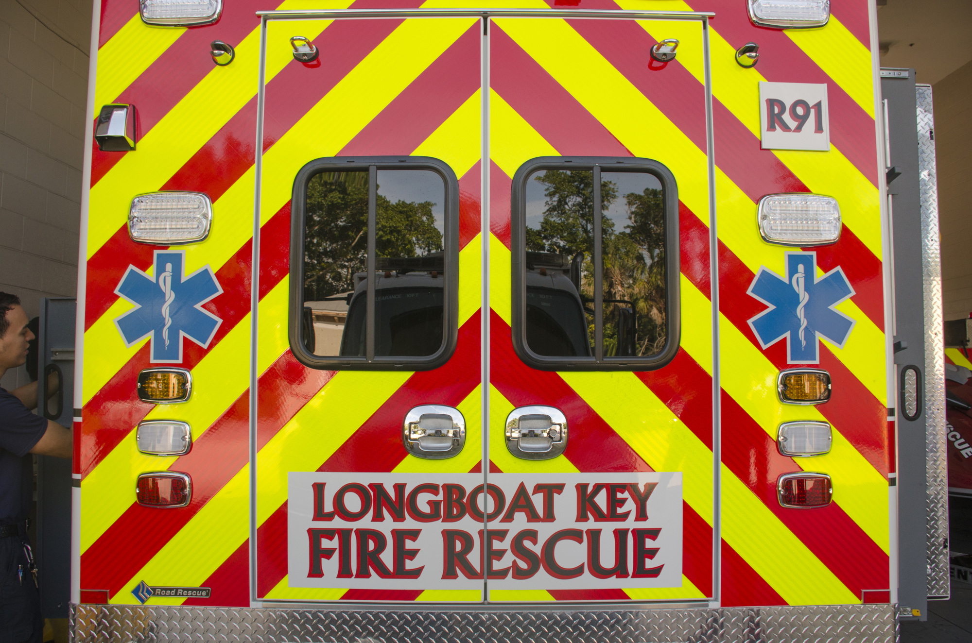 A reflective yellow and red chevron pattern covers the back of the truck, a Florida Department of Transportation requirement for all fire/rescue vehicles.