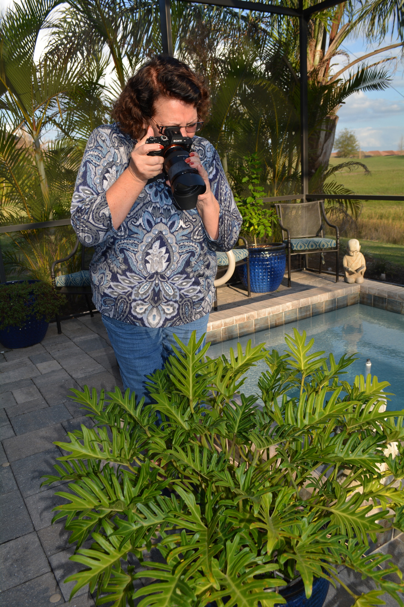 Kathryn DeYoung photographs a plant in her backyard. She likes to use images she's taken and combine them with others.