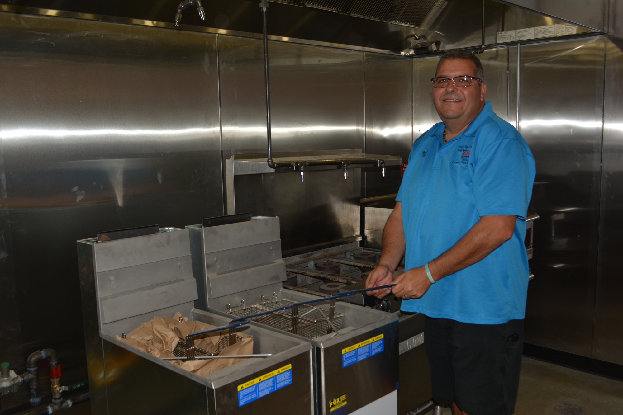 Elks Trustee Darrin Simone shows off two deep fat friers. The old lodge didn't have a kitchen.
