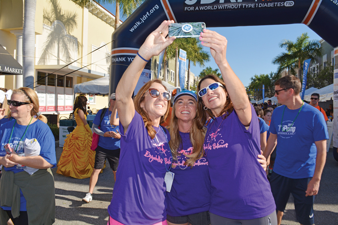 Karen Johnson, Kelly Nebel and Tessa Juall, all of Sarasota, pause for a selfie just past the starting line of the 2017 One Walk event.