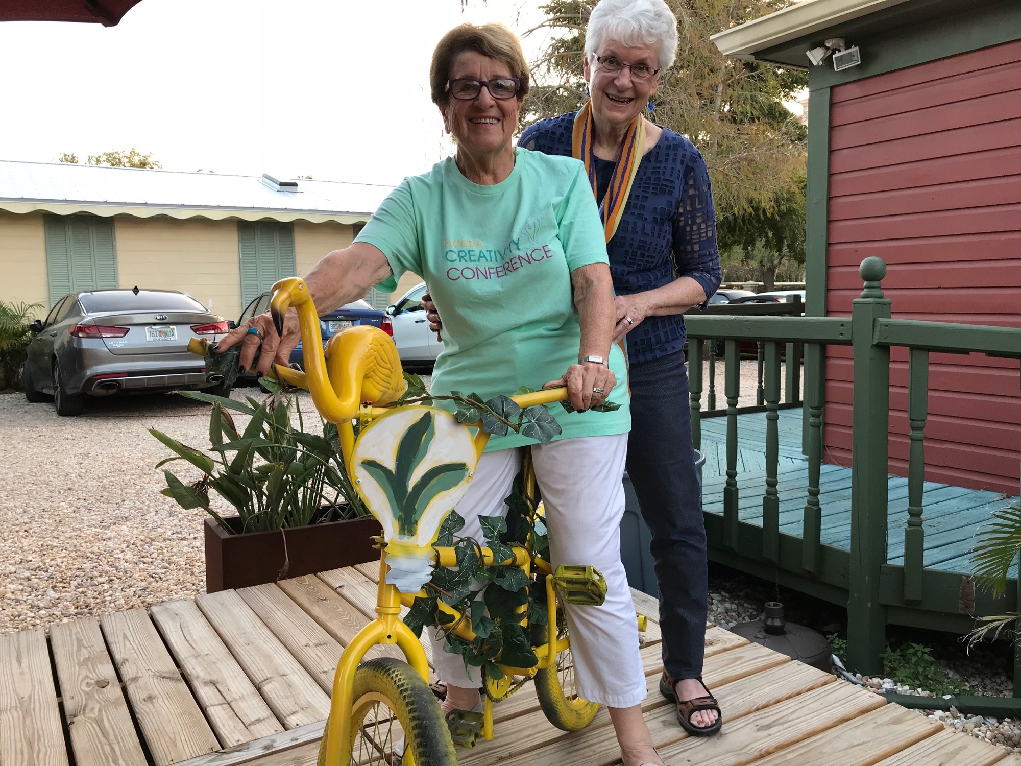 Florida Creativity Conference Co-Chairwomen Hedria Lunken Saltzman Kitty Heusner show off the bike made by Sarasota creator William Pearson in honor of the 2018 conference theme: Grow Your Creativity. Courtesy image