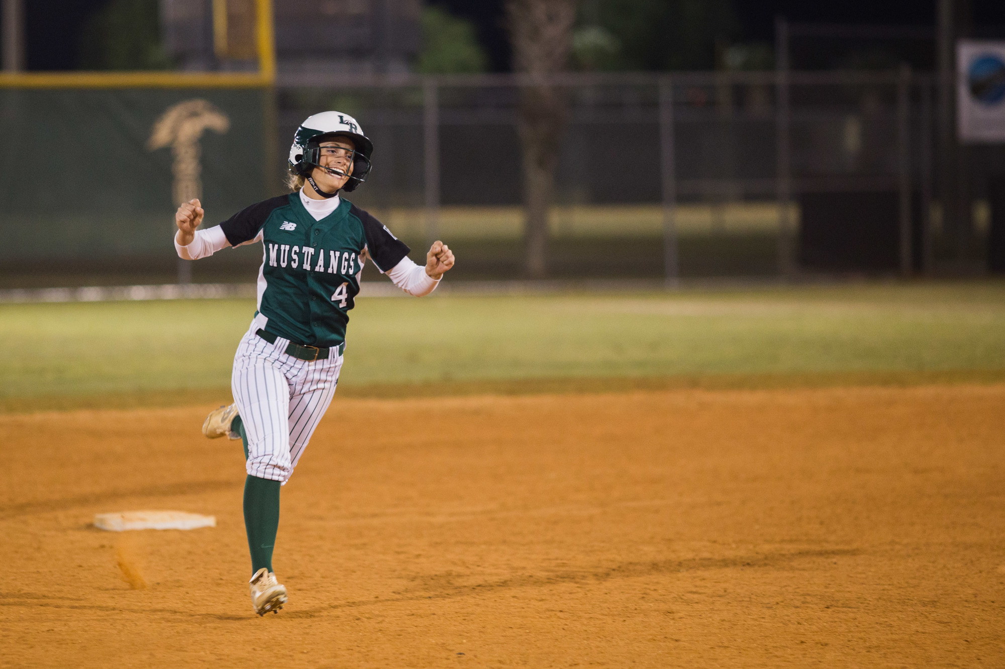 Senior Olivia Danko raises her fists while rounding the bases. Photo by Kayleigh Omang.